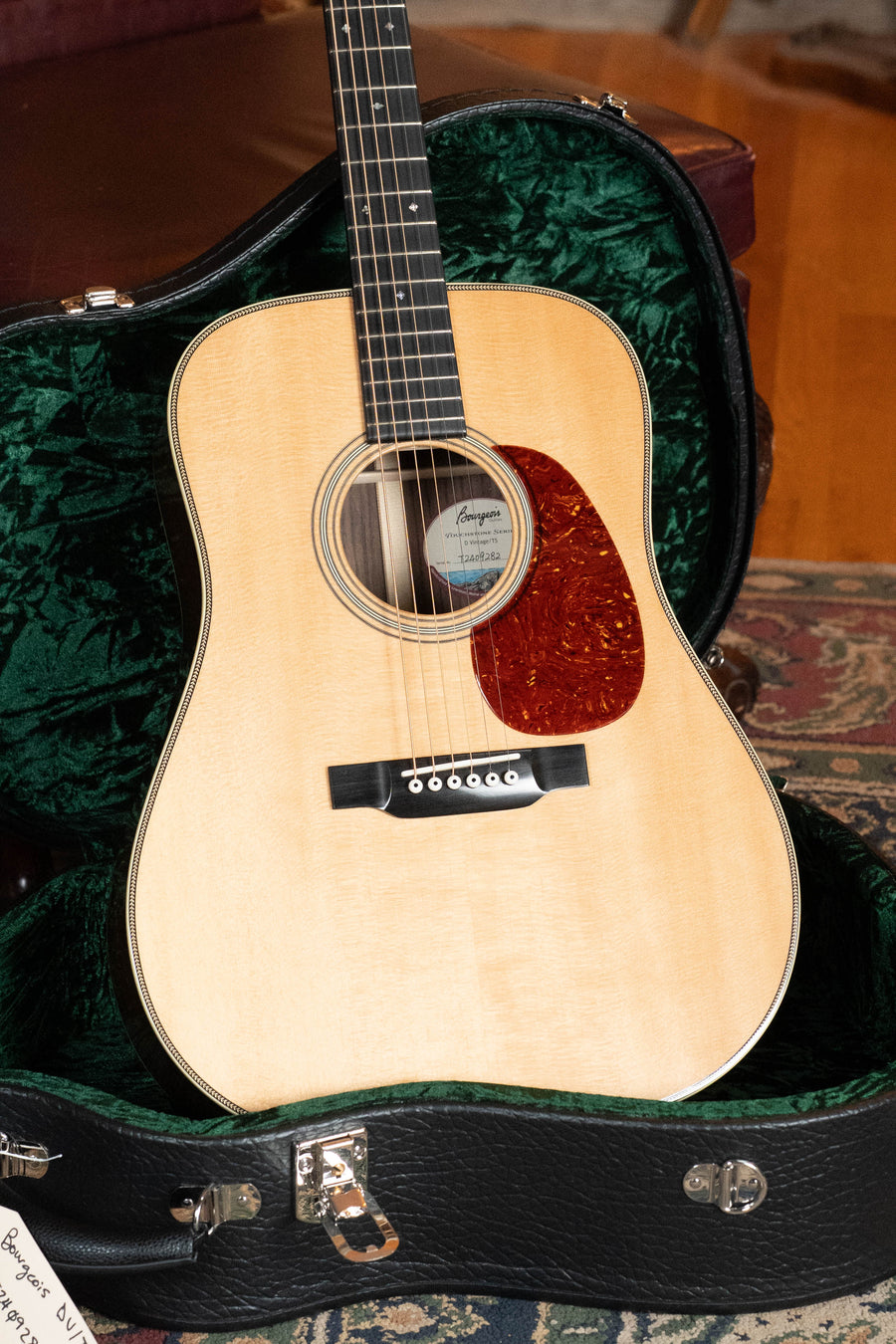 A Bourgeois D Vintage/TS Touchstone Series Sitka/Rosewood Dreadnought Acoustic Guitar #9282 rests in an open, green velvet-lined black case on a patterned rug.