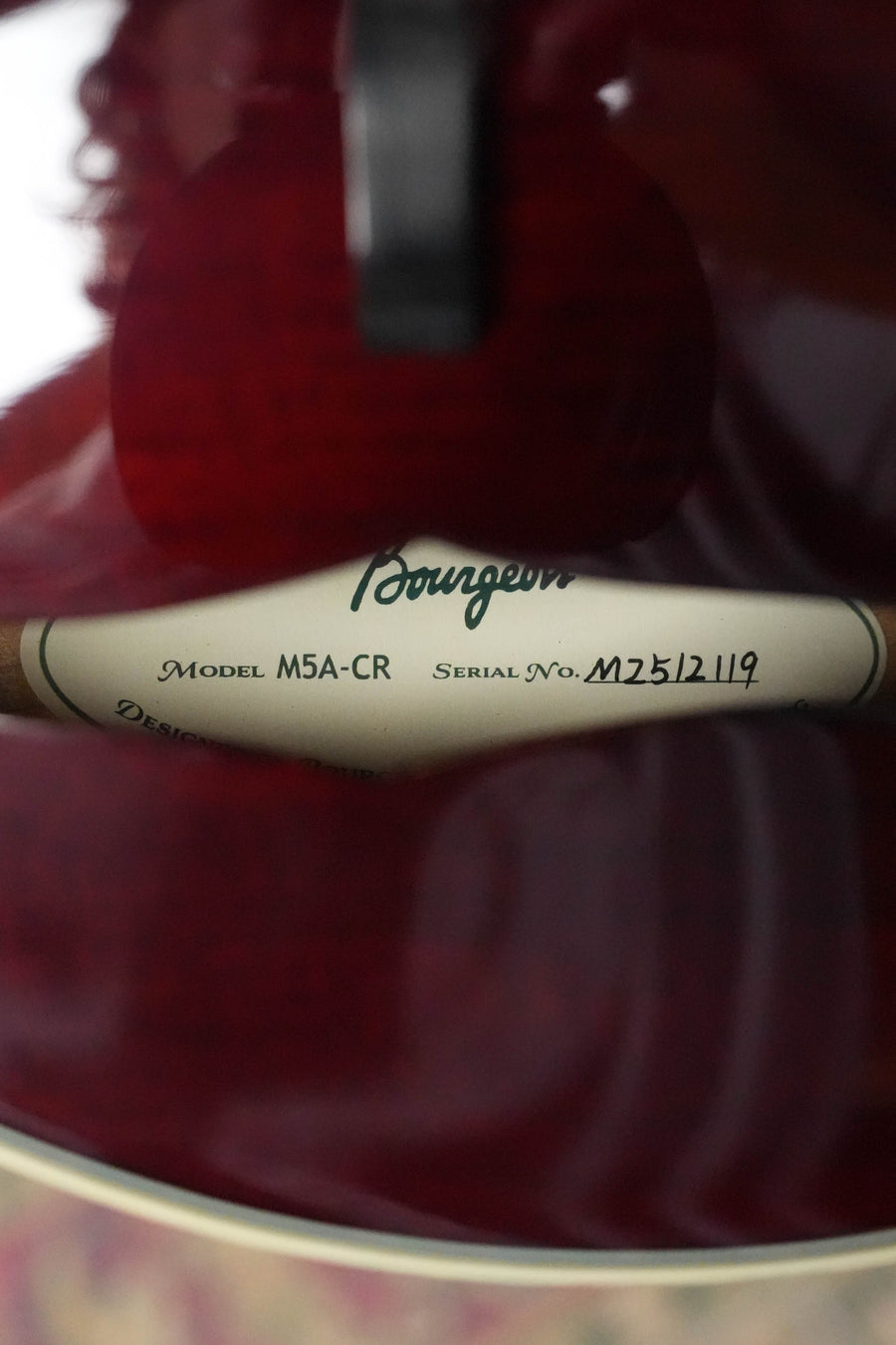 Close-up of a Bourgeois TAS Exclusive M5-A-CR Aged-Tone Adirondack/Maple Cordovan Red A-Style Mandolin's interior label, showing the model and serial number #2119 through the sound hole.