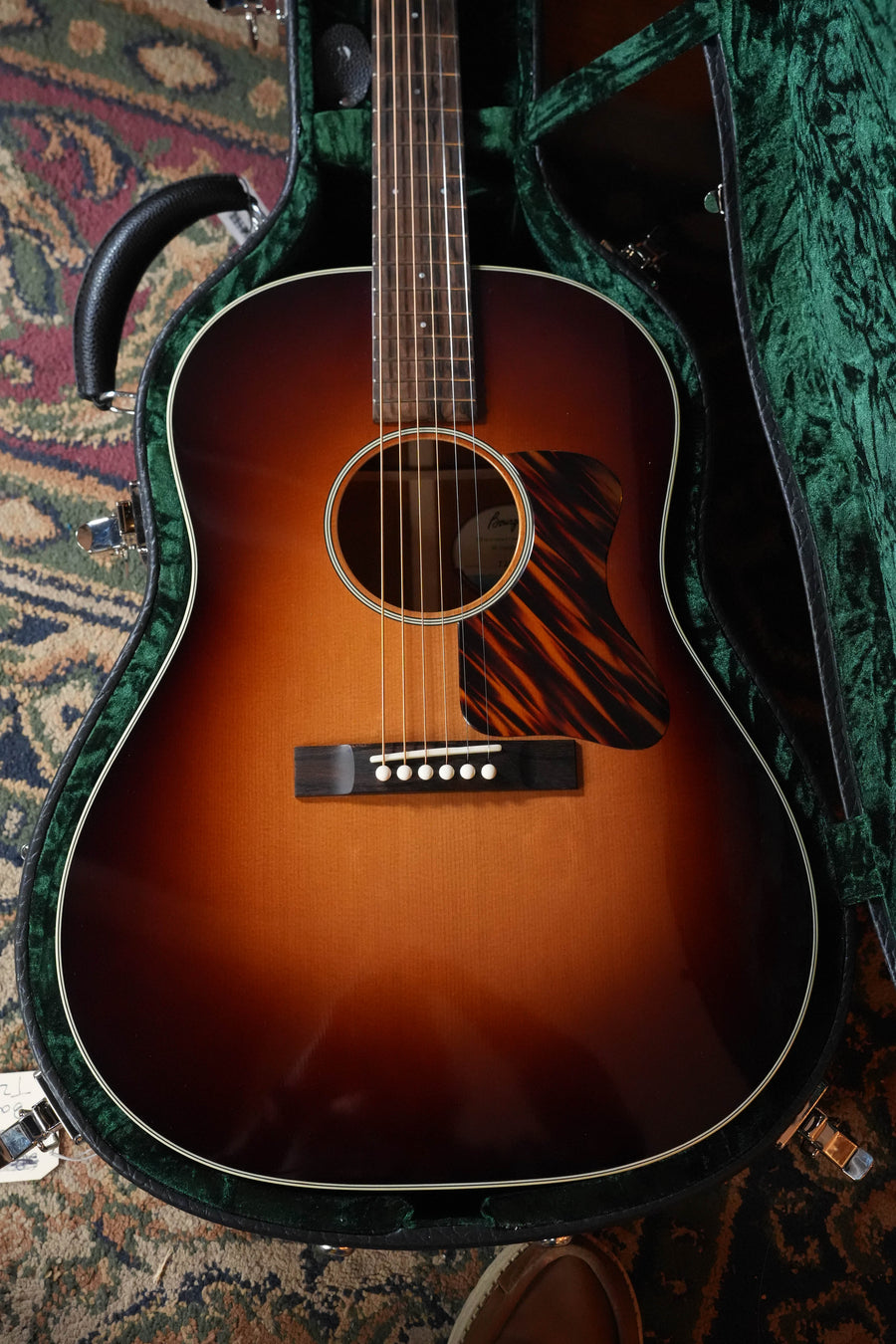The Bourgeois The Standard SDS/TS Touchstone Series Sunburst Slope Shoulder Dreadnought Acoustic Guitar #2244 rests in a green-lined hard case on a patterned carpet.