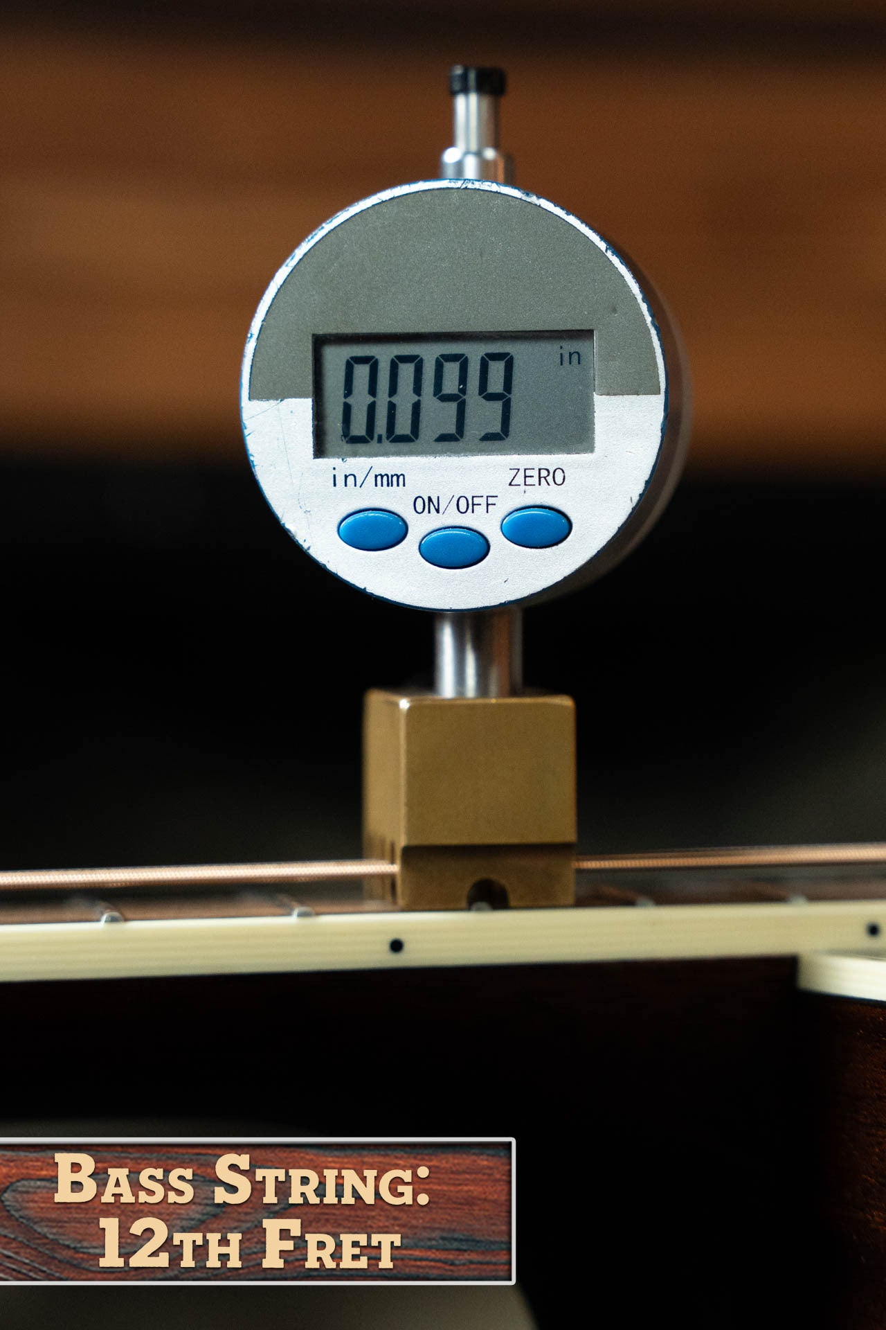 A digital caliper measures the string height at the 12th fret of a Bourgeois Blues PSBB-LDBO-S Satin Professional Series All Mahogany OO Acoustic Guitar #1197, showing 0.099 inches. Label: Bass String: 12th Fret.