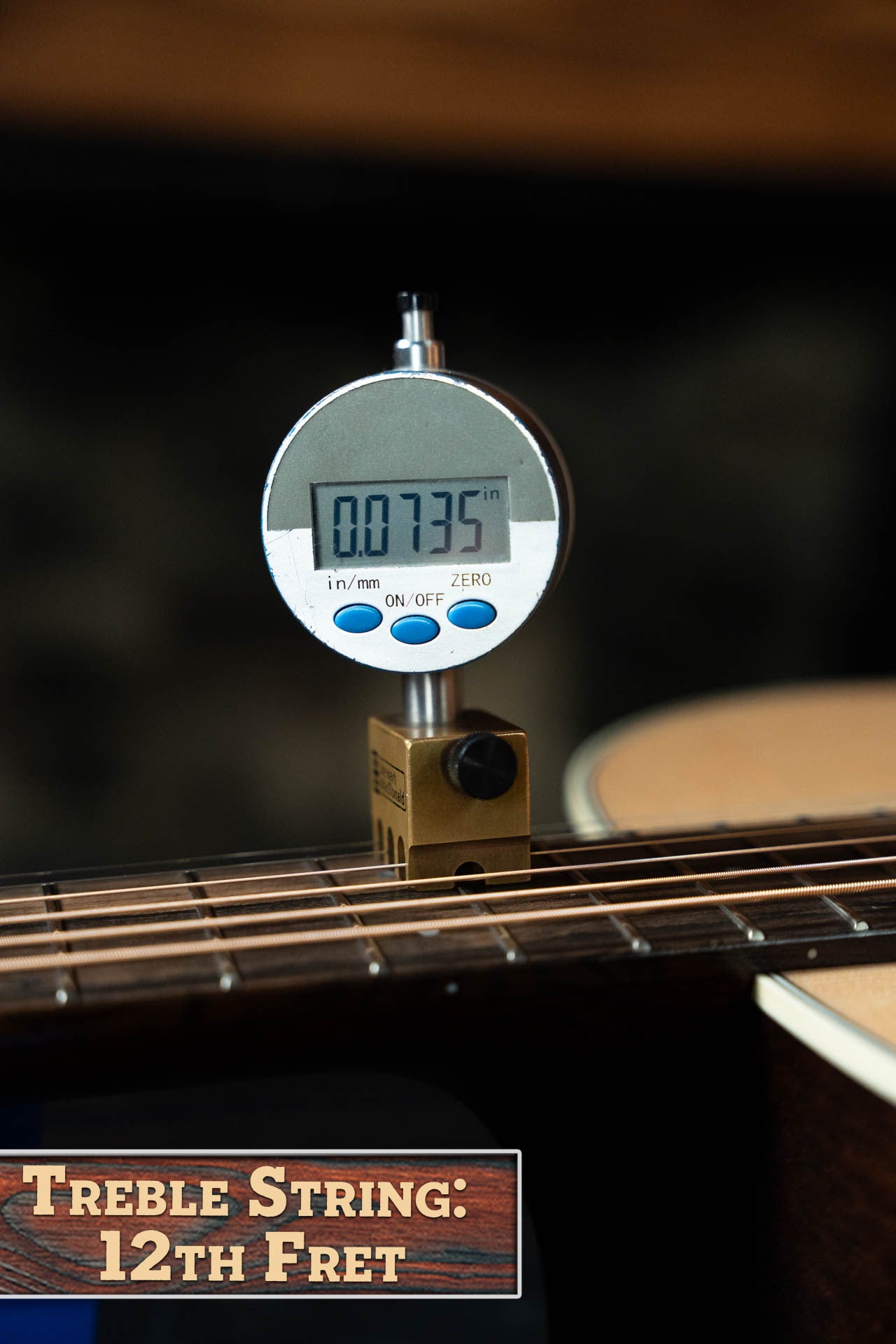 A digital gauge shows the action height above the 12th fret on a Boucher Guitars Bourgeois PSN-SD-S Satin Professional Series Dreadnought (#1174) treble string as 0.0735 inches. A sign reads: Treble String: 12th Fret.