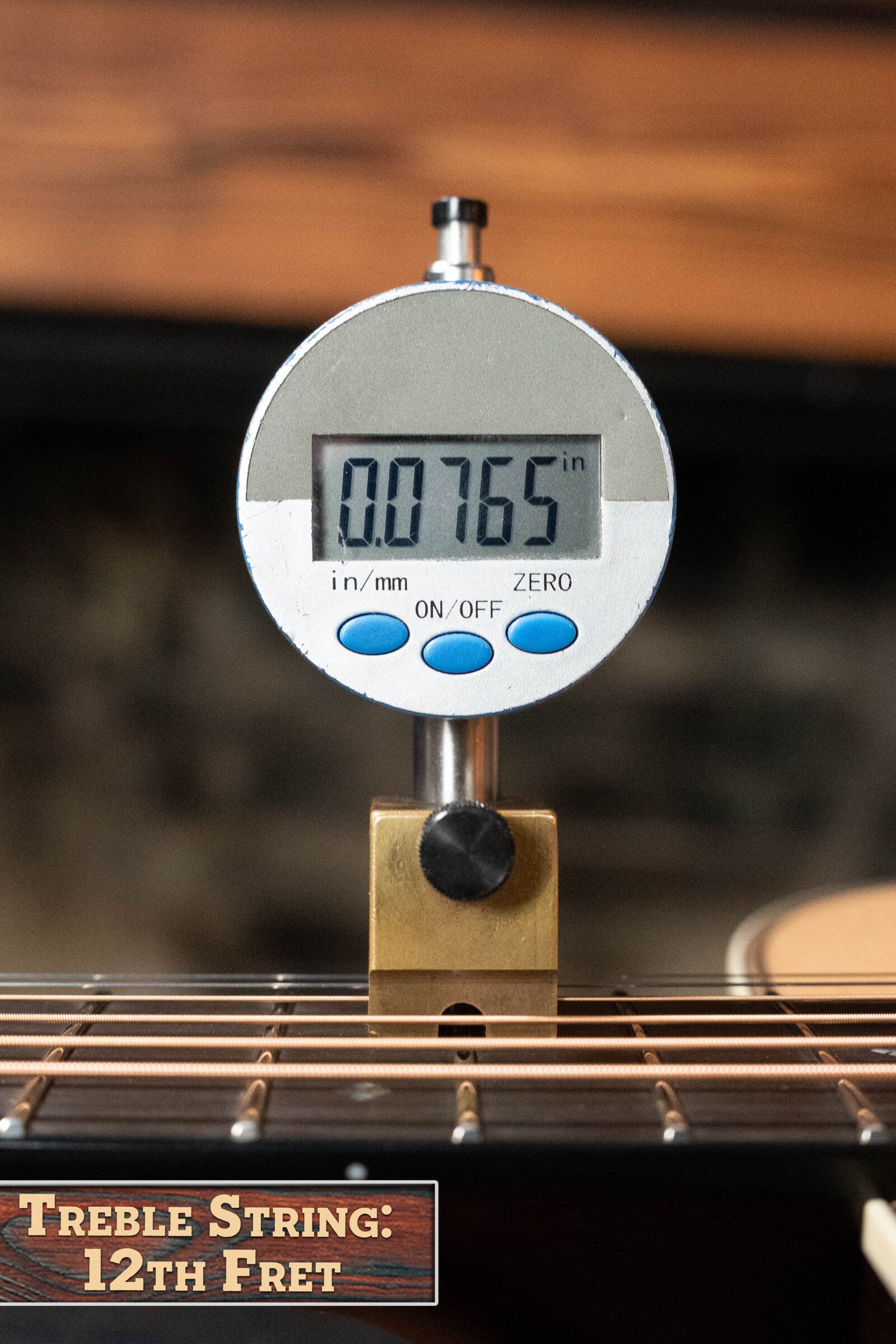A digital gauge measures 0.0765 above the treble string at the 12th fret of this Bourgeois PSV-D-S Professional Series Sitka/Rosewood Vintage Satin Dreadnought #1124. A label at bottom left reads Treble String: 12th Fret.