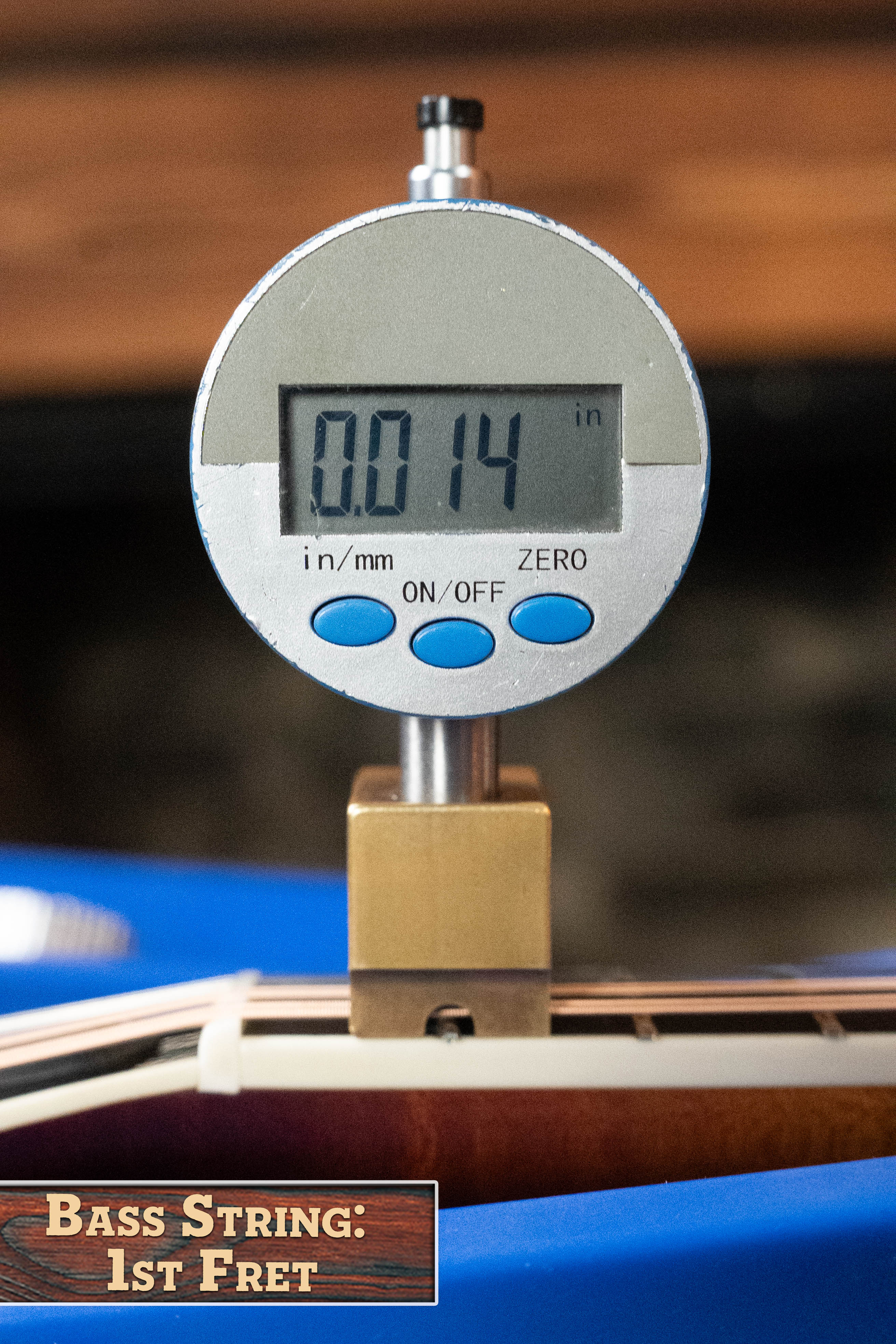 A digital gauge shows 0.014 inches above a bass string at the 1st fret, with a label: "Bass String: 1st Fret," demonstrating precision like that used for the Bulas Carpathian Spruce/Curly Maple Cremona Sunburst A-Style Mandolin #8129 by Bulas.