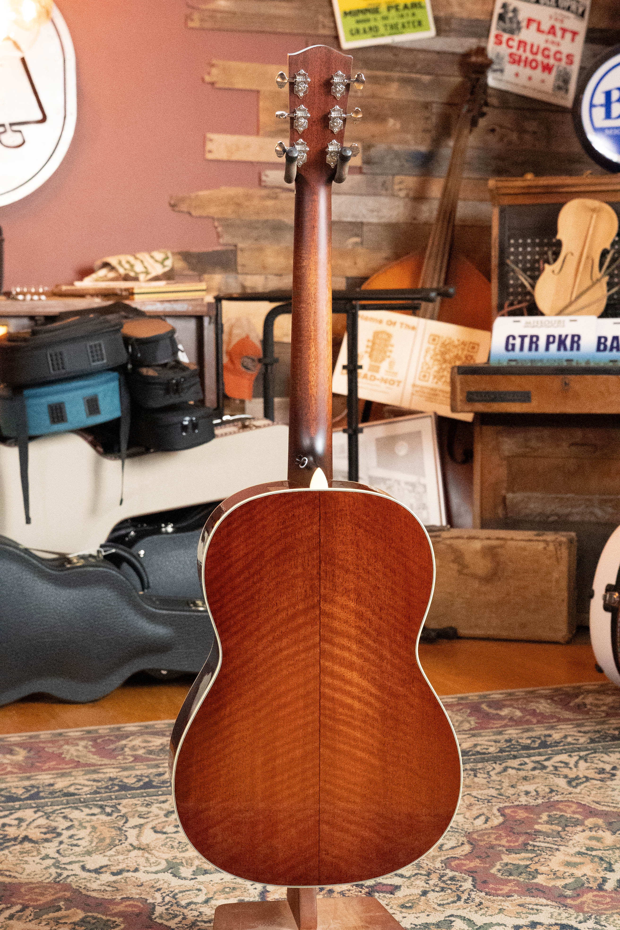 The *Dread-Not Certified Used* Eastman E6-LGSS-TC-SB acoustic guitar by Eastman Guitars features a thermo-cured Sitka spruce top and mahogany back/sides in sunburst, its glossy finish elegantly showing the wood grain.