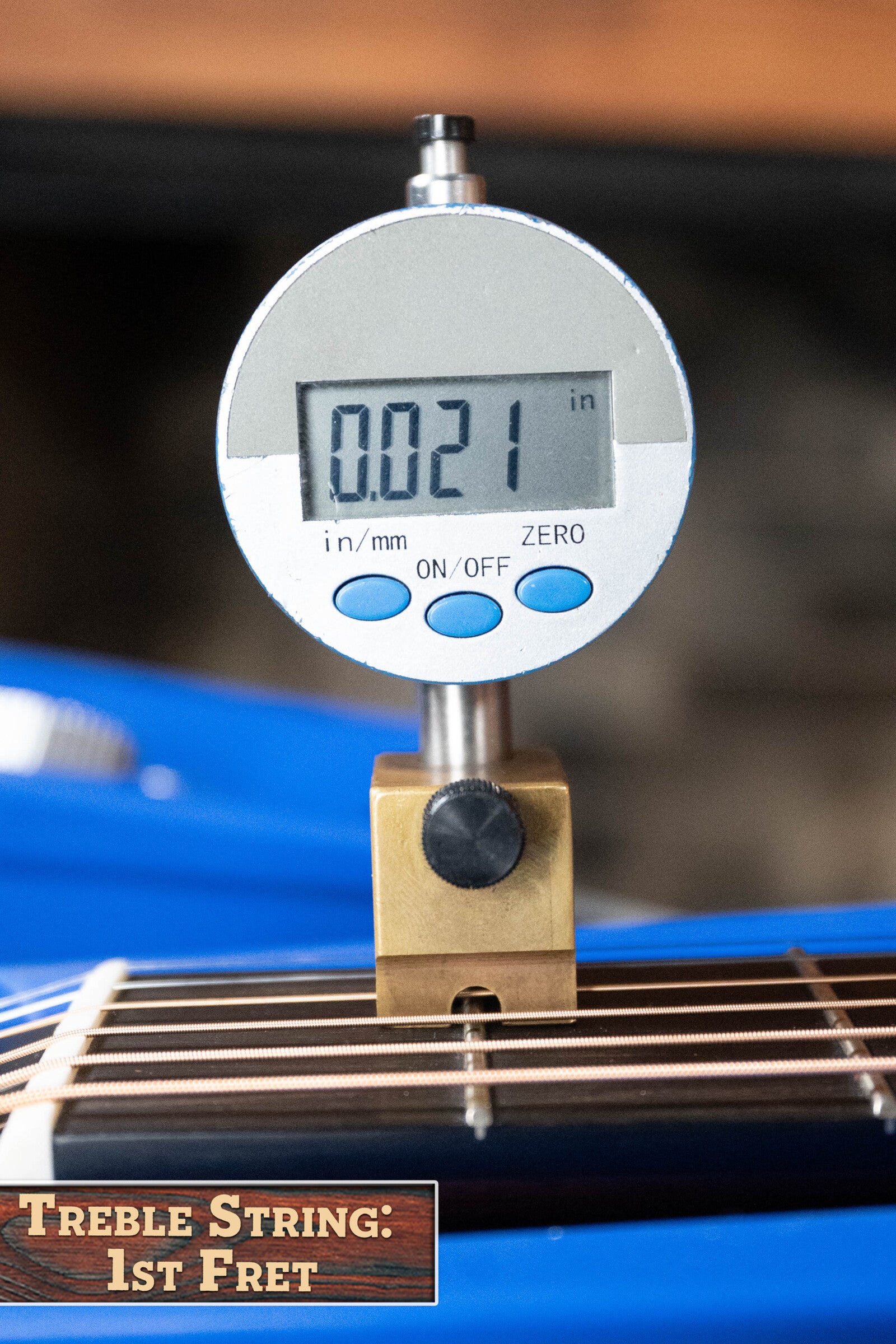 A digital gauge shows 0.021 inches measuring the treble string height at the 1st fret on a *Dread-Not Certified Used* Boucher BG-52-GM Bluegrass Goose Series Dreadnought by Boucher Guitars; Treble String: 1st Fret appears in a wood-themed text box.