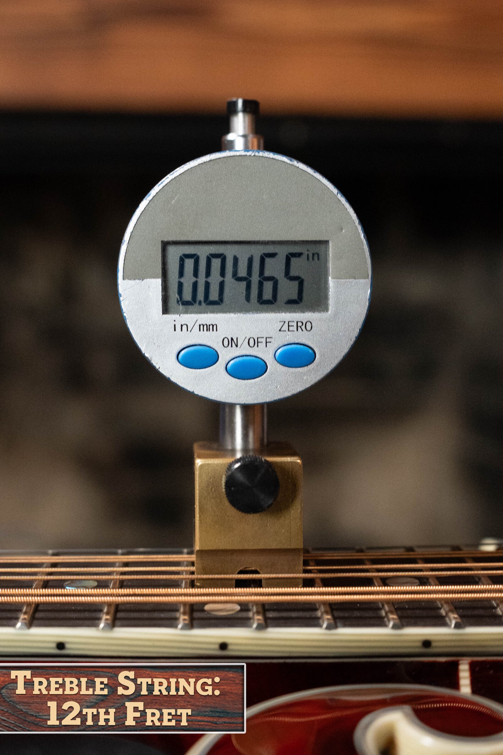 A digital gauge reads 0.0465" on the treble string at the 12th fret of a *Dread-Not Certified Used* Eastman MDA815 F-Style Mandola Classic Finish #4978 by Eastman Guitars, highlighting its solid spruce top.