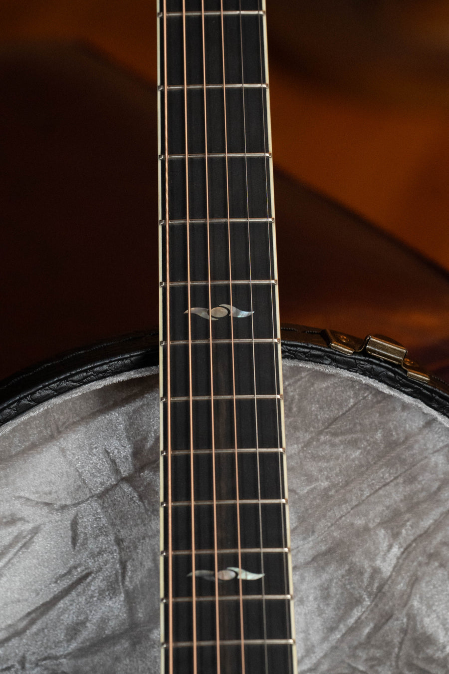 Close-up of the neck and upper body of the Eastman Guitars AC322CE Sitka/Mahogany Grand Auditorium Cutaway, highlighting strings, frets, and Sitka Spruce inlays against a softly blurred background.