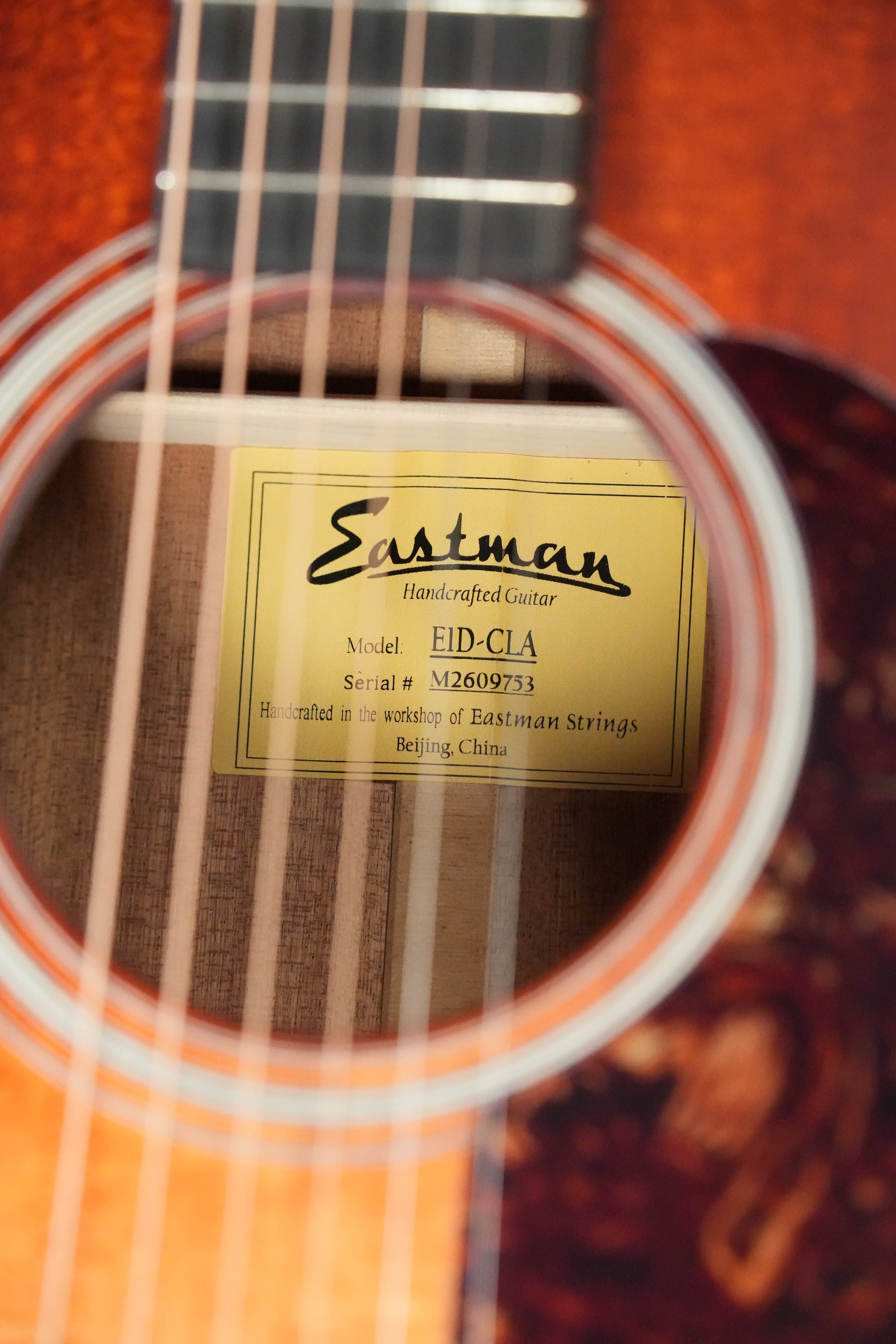 Close-up of the Eastman E1D-CLA Classic Finish Dreadnought Acoustic Guitar #9753 by Eastman Guitars, showing the inside label. This model features a solid Sitka spruce top and is handcrafted in Beijing, China.