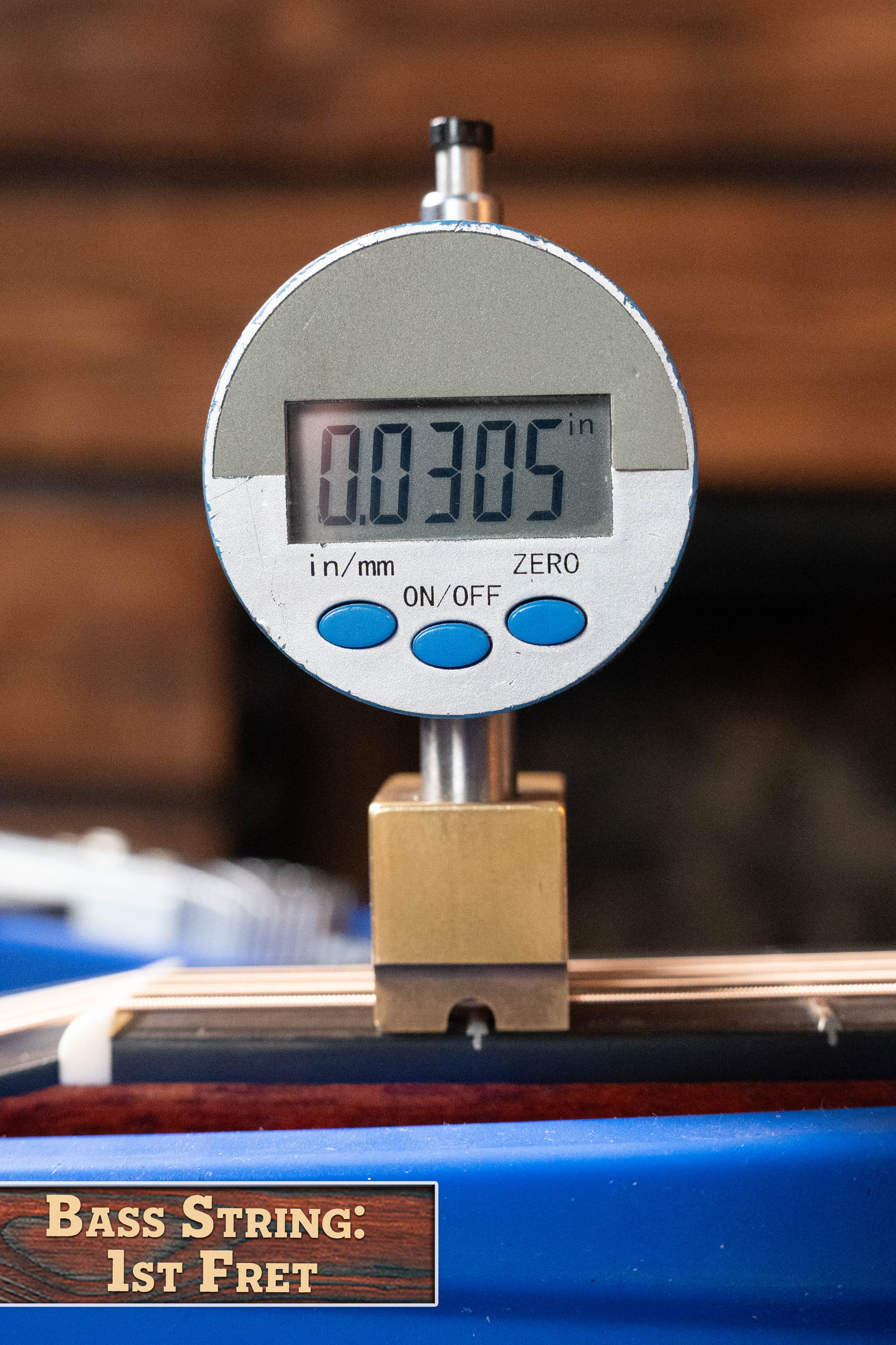 A digital gauge reads 0.0305 inches above the 1st fret of a bass string, matching the precise setup on an Eastman Guitars E1D Sitka/Sapele Dreadnought Acoustic Guitar #6855. Label: Bass String: 1st Fret.