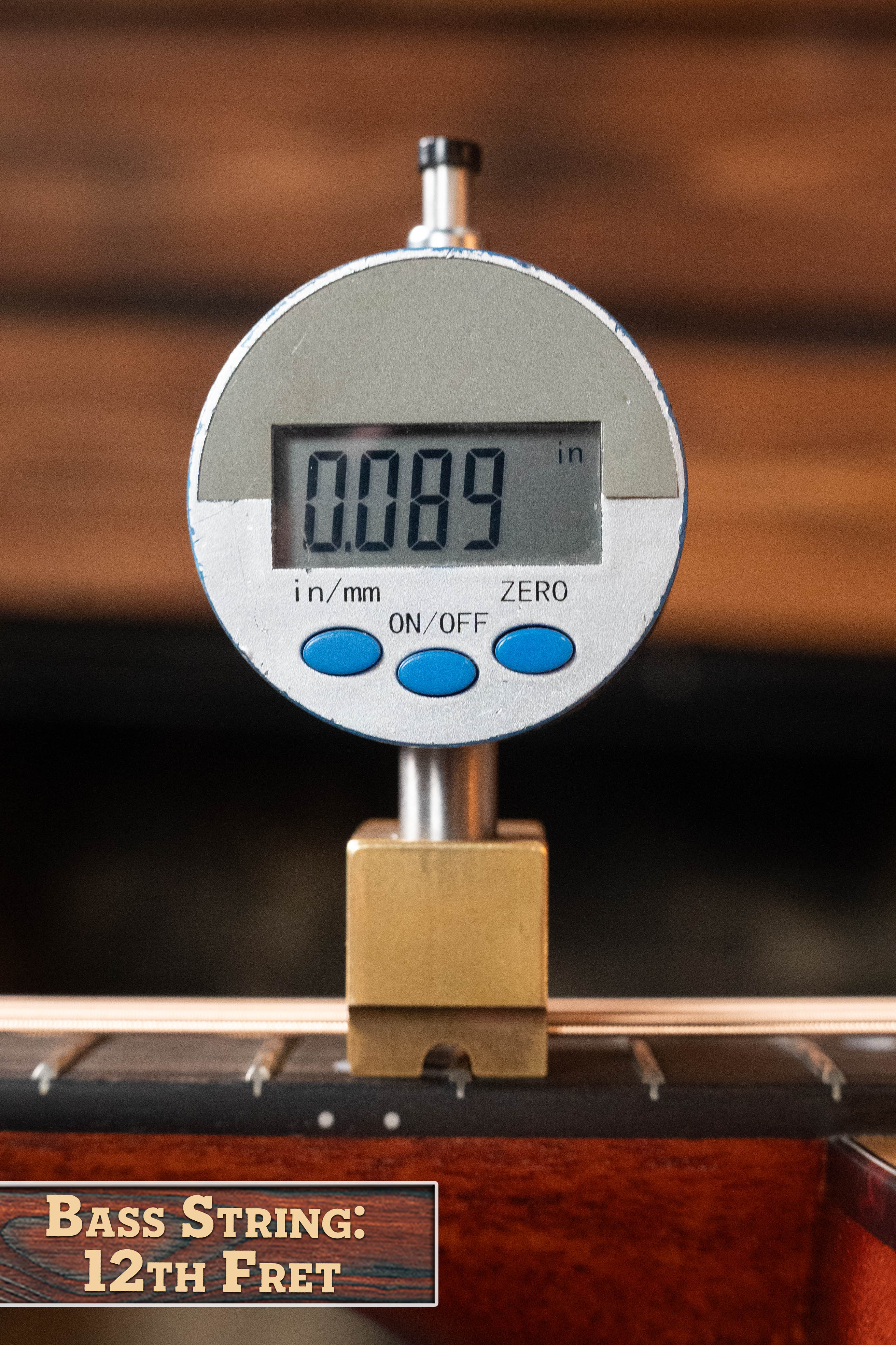 A digital caliper shows 0.089 inches above the bass string at the 12th fret of an Eastman Guitars E1D Sitka/Sapele Dreadnought Acoustic Guitar #6855.
