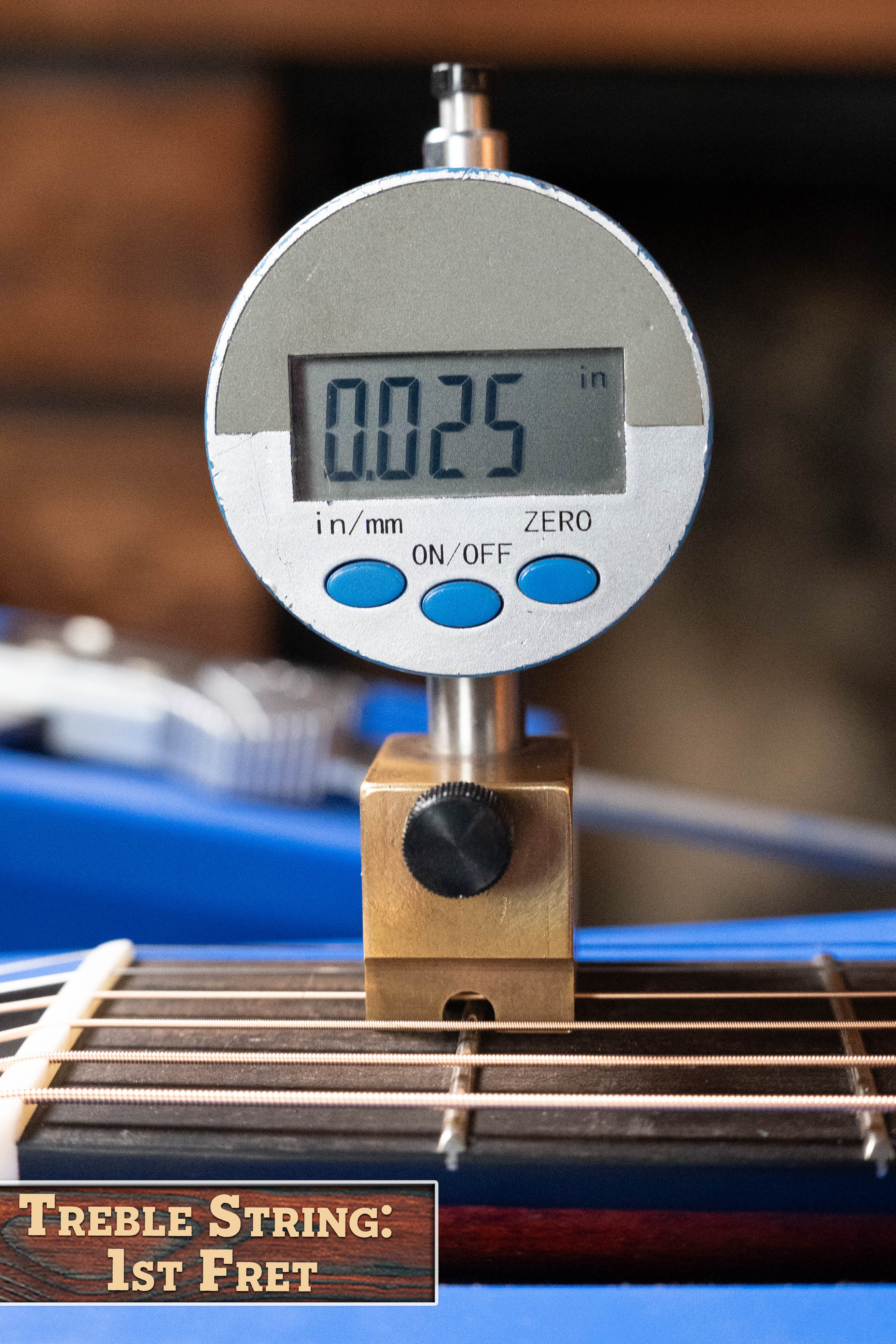 A digital gauge shows 0.025 in when measuring the treble string height at the 1st fret of the Eastman Guitars E1D Sitka/Sapele Dreadnought Acoustic Guitar #6855. A corner label states Treble String: 1st Fret.