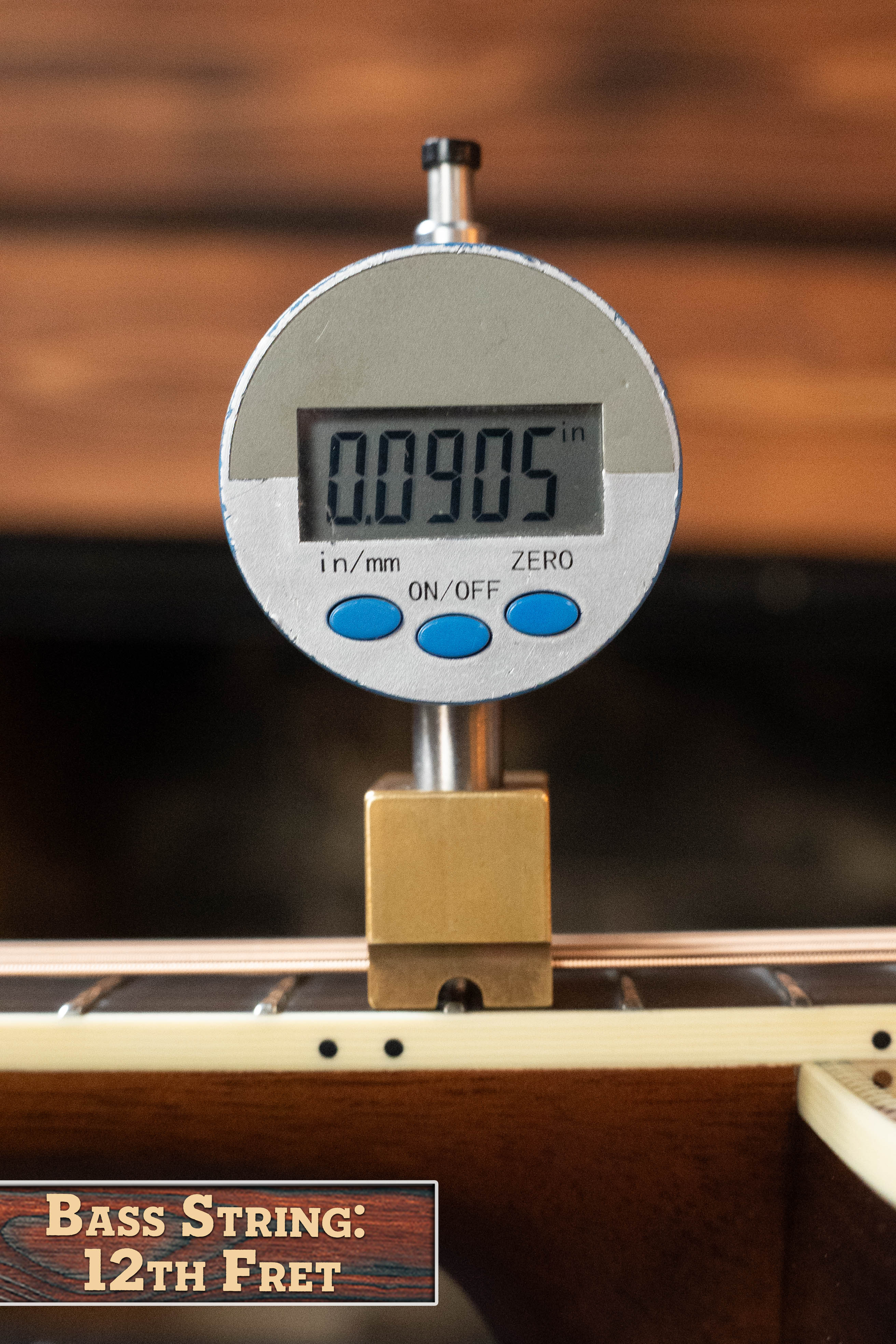 A digital caliper measures the 12th fret action of an Eastman Guitars E20D-LSH-TC Thermo-Cured Adirondack/Rosewood Dreadnought (#8072) string at 0.0905 inches; label notes large soundhole and torrefied top.