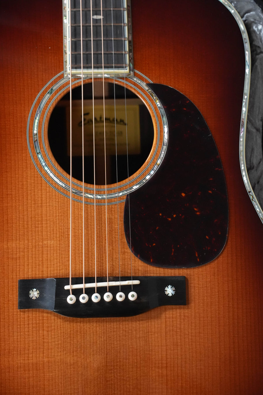 Close-up of the Eastman Guitars E40D-TC-SB Dreadnought #5274, highlighting its AAA Grade thermo-cured Adirondack top, rosewood body, sunburst finish, strings, sound hole, pickguard, and fretboard.