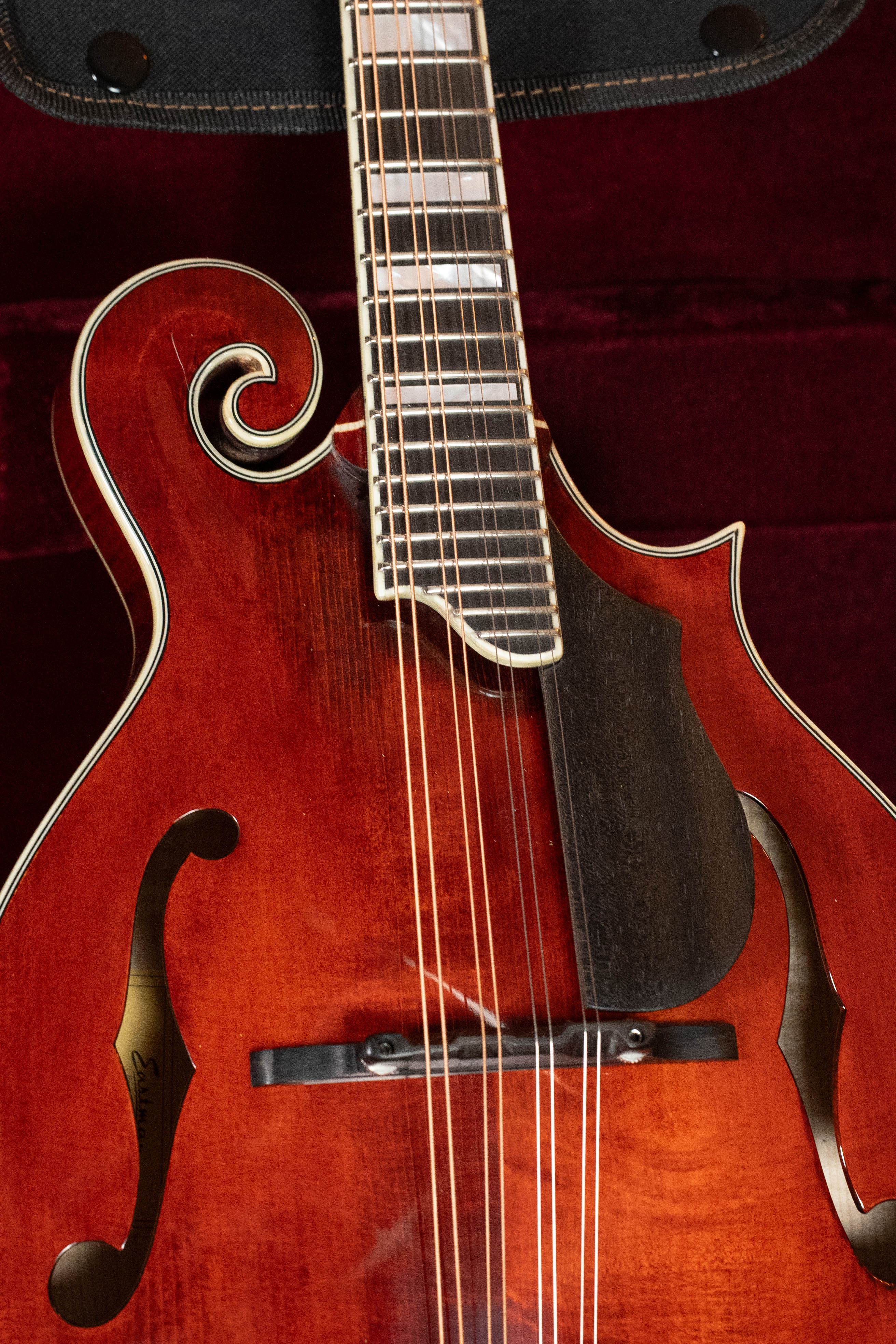 A close-up of a guitar, showcasing intricate details similar to those on the Eastman Guitars MD615 Spruce/Maple F-Style Mandolin w/K&K Pickup #3918.