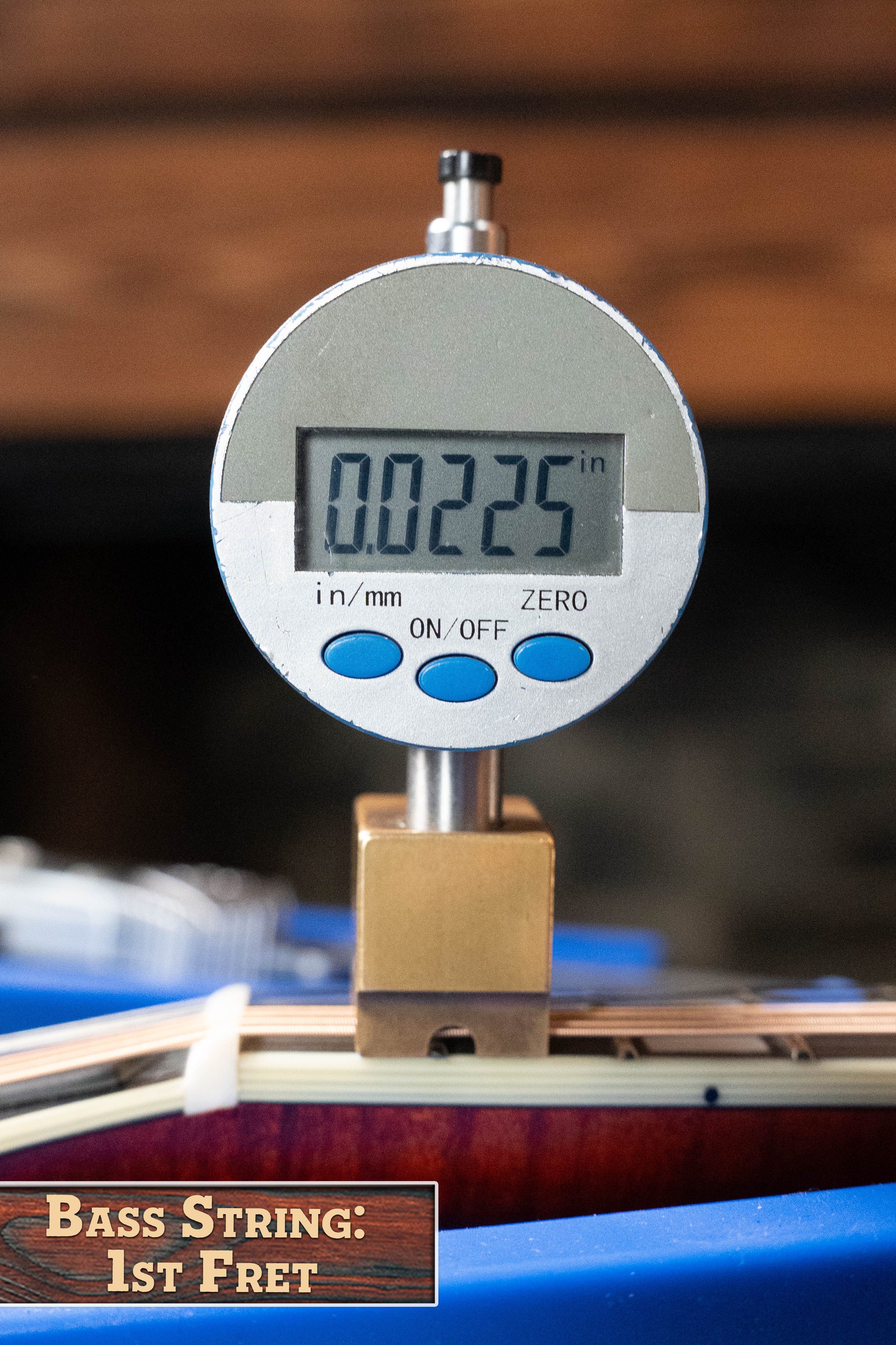 A digital gauge shows 0.0225 inches for bass string height at the 1st fret, labeled "Bass String: 1st Fret," similar to setups on top instruments like the Eastman MD615 Spruce/Maple F-Style Mandolin w/K&K Pickup #3918 by Eastman Guitars.