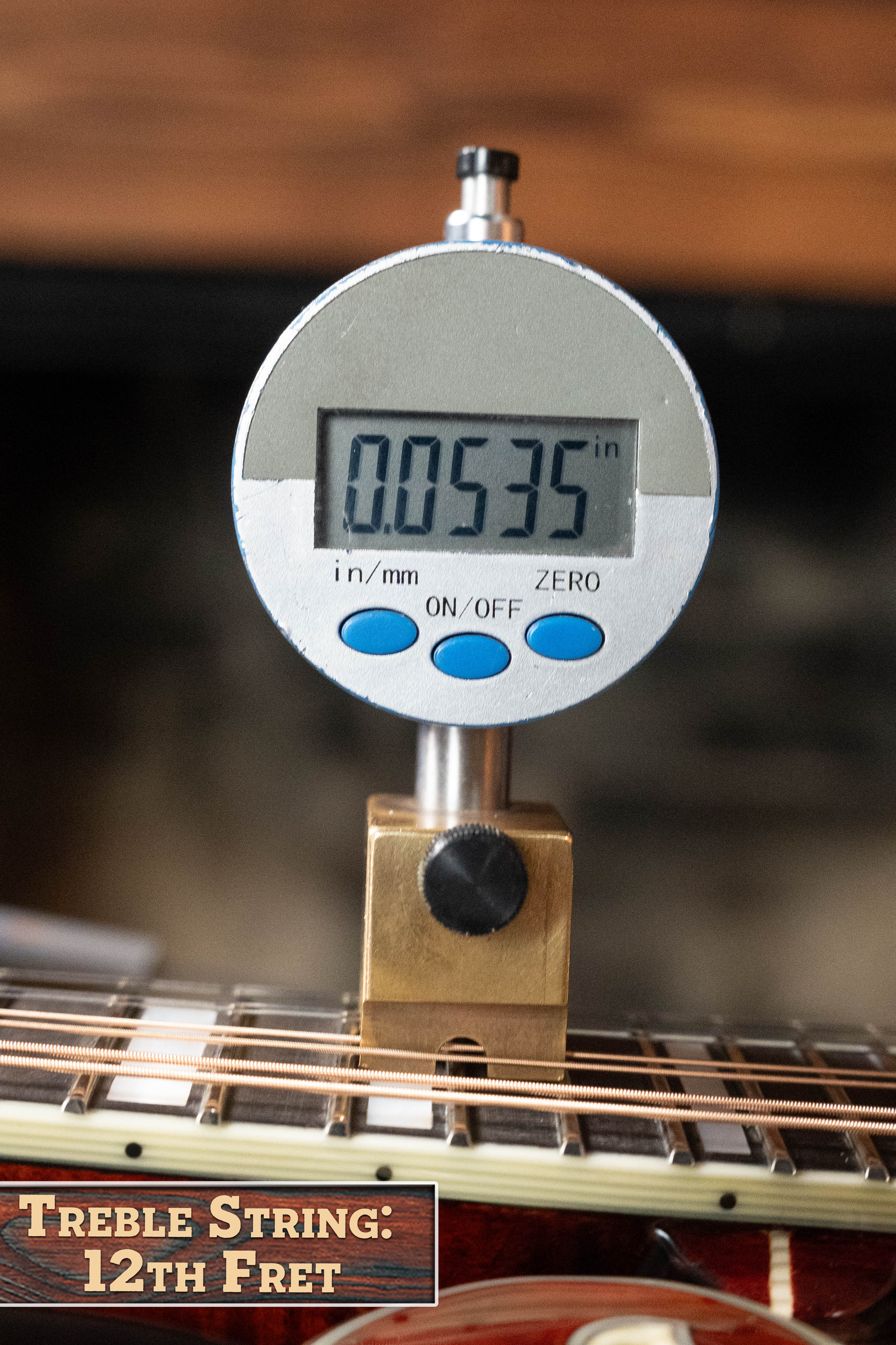 A digital gauge reads 0.0535 inches for the treble string height at the 12th fret, labeled “Treble String: 12th Fret,” next to an Eastman Guitars MD615 Spruce/Maple F-Style Mandolin w/K&K Pickup #3918.