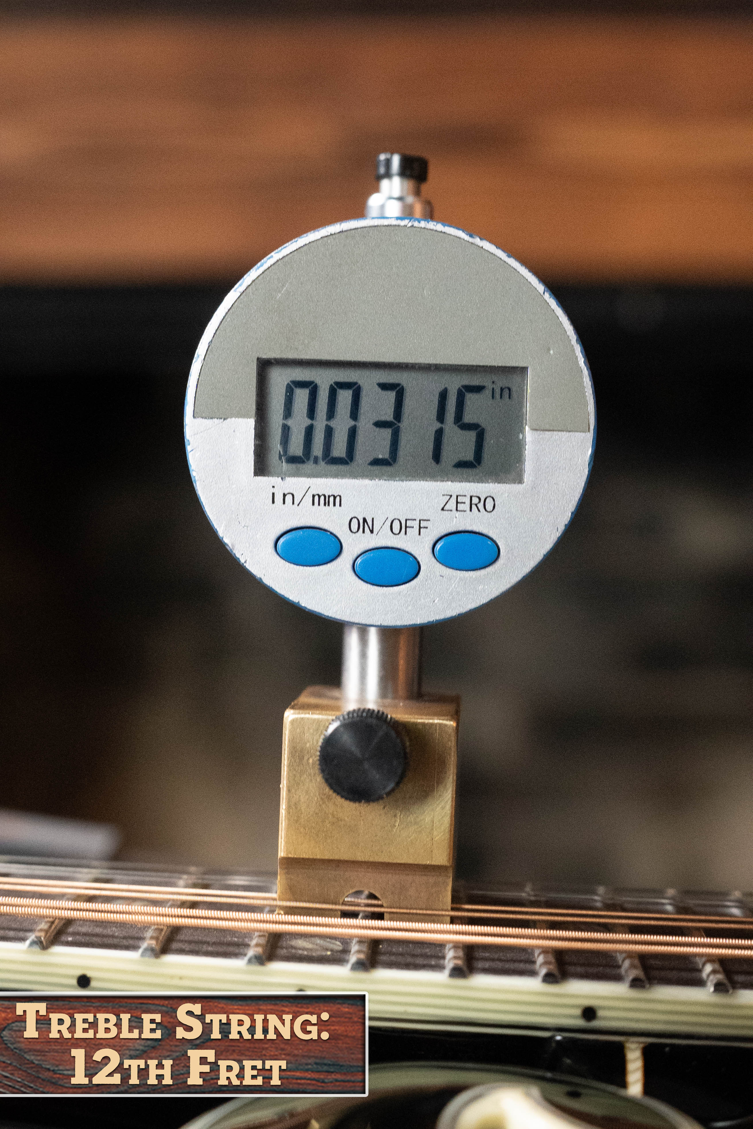 A digital gauge reads 0.0315 inches above the treble strings at the 12th fret of an Eastman Guitars MD815-SB Adirondack/Flamed Maple Sunburst F-Style Mandolin #3355.