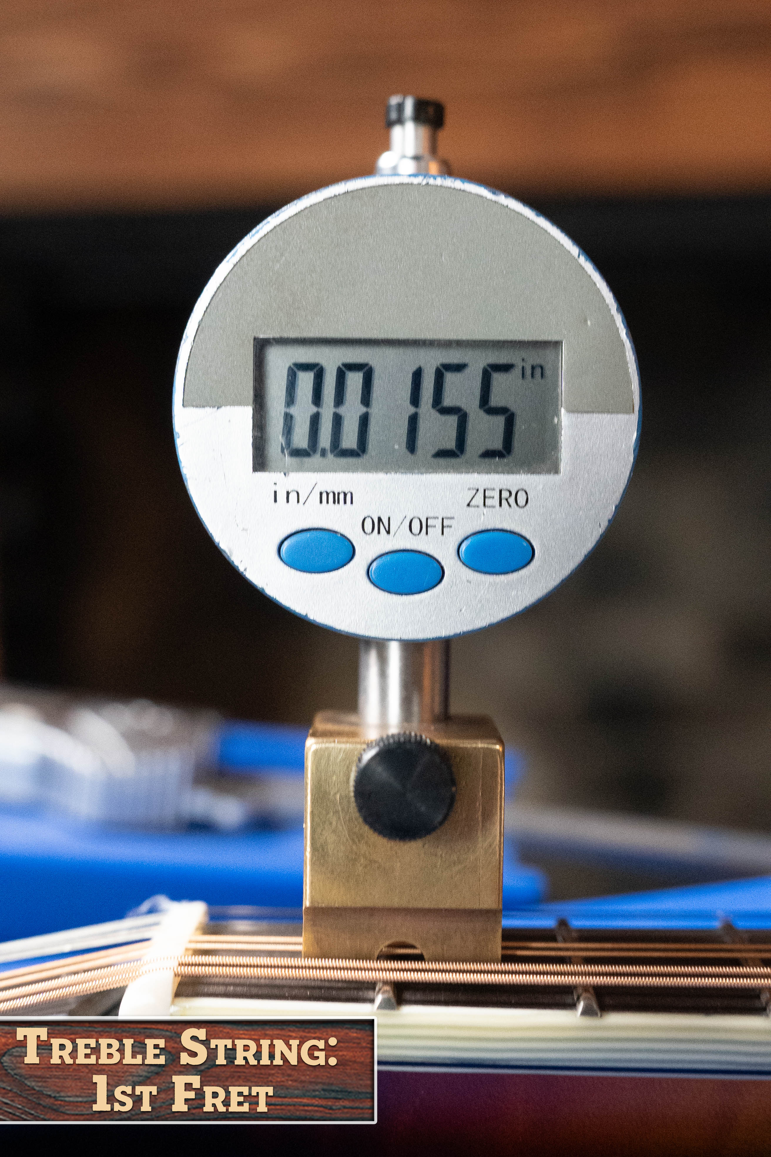 A digital gauge shows 0.155 inches, measuring the treble string height at the 1st fret of an Eastman Guitars MD815-SB Adirondack/Flamed Maple Sunburst F-Style Mandolin #3356. Label: Treble String: 1st Fret.