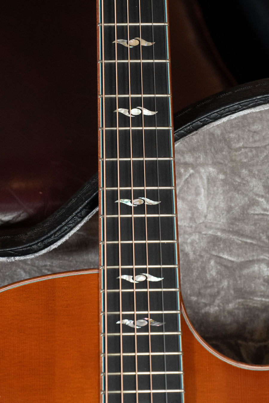 Close-up of a *Dread-Not Certified Used* Eastman Guitars AC522CE-GB Grand Auditorium with wing inlay neck, European spruce top, mahogany body, and LR Baggs pickup, shown in its gray plush-lined case.