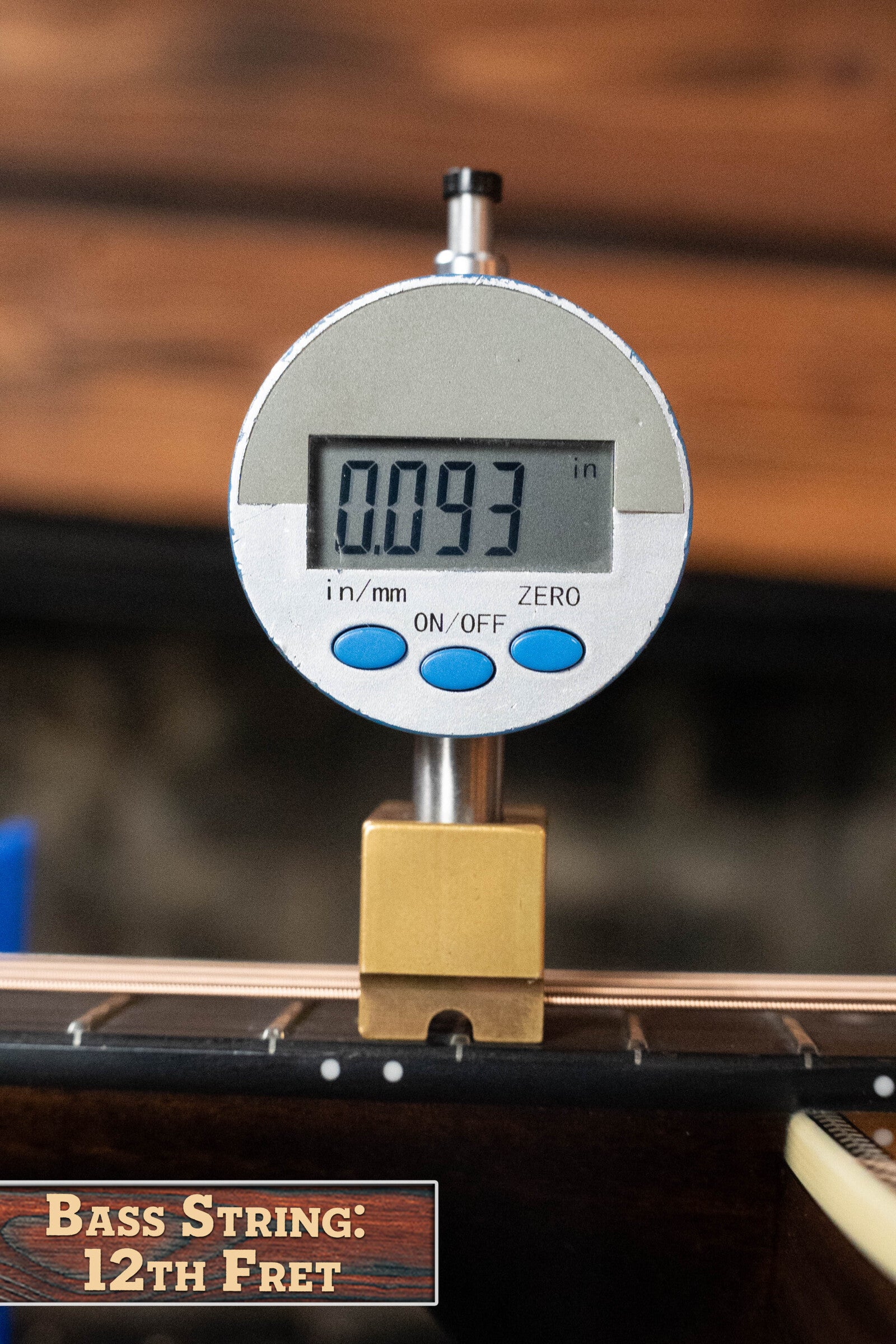 A digital gauge shows 0.093 inches, measuring bass string height at the 12th fret. Below, a label reads: Bass String: 12th Fret on wood, evoking the Eastman Guitars E20D-TC Thermo-Cured Adirondack/Rosewood Dreadnought #8128.