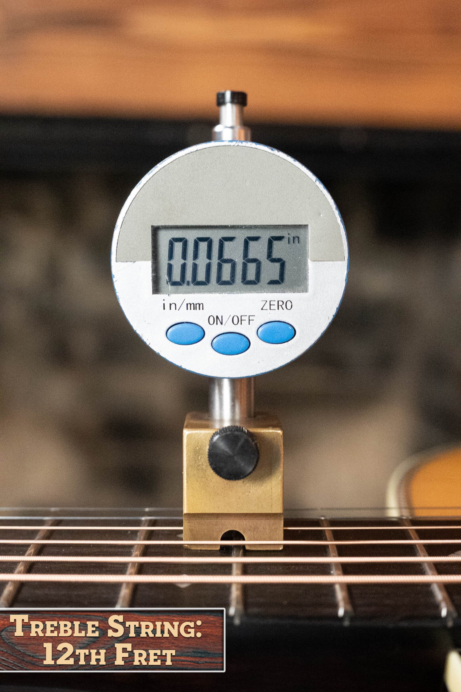 A digital gauge shows 0.0665 inches when measuring the treble string height at the 12th fret on an Eastman Guitars E20OM-TC Thermo-Cured Adirondack/Rosewood Orchestra Model Acoustic Guitar #3015. Label: Treble String: 12th Fret.