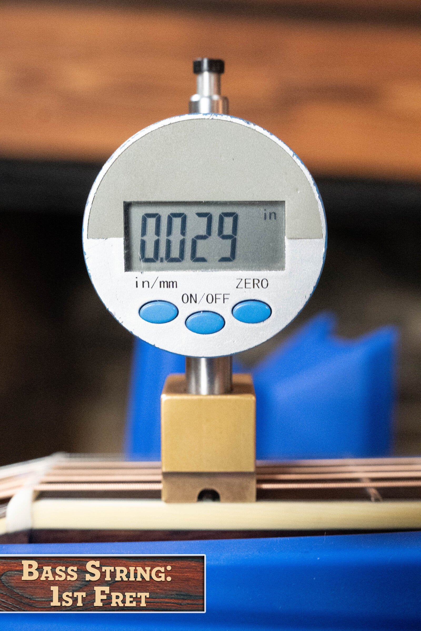 A digital caliper shows 0.029 for the bass string at the 1st fret—ideal for setups on instruments like the Eastman Guitars E40D-TC-SB Thermo-cured AAA Grade Adirondack/Rosewood Sunburst Dreadnought Acoustic Guitar #1113.
