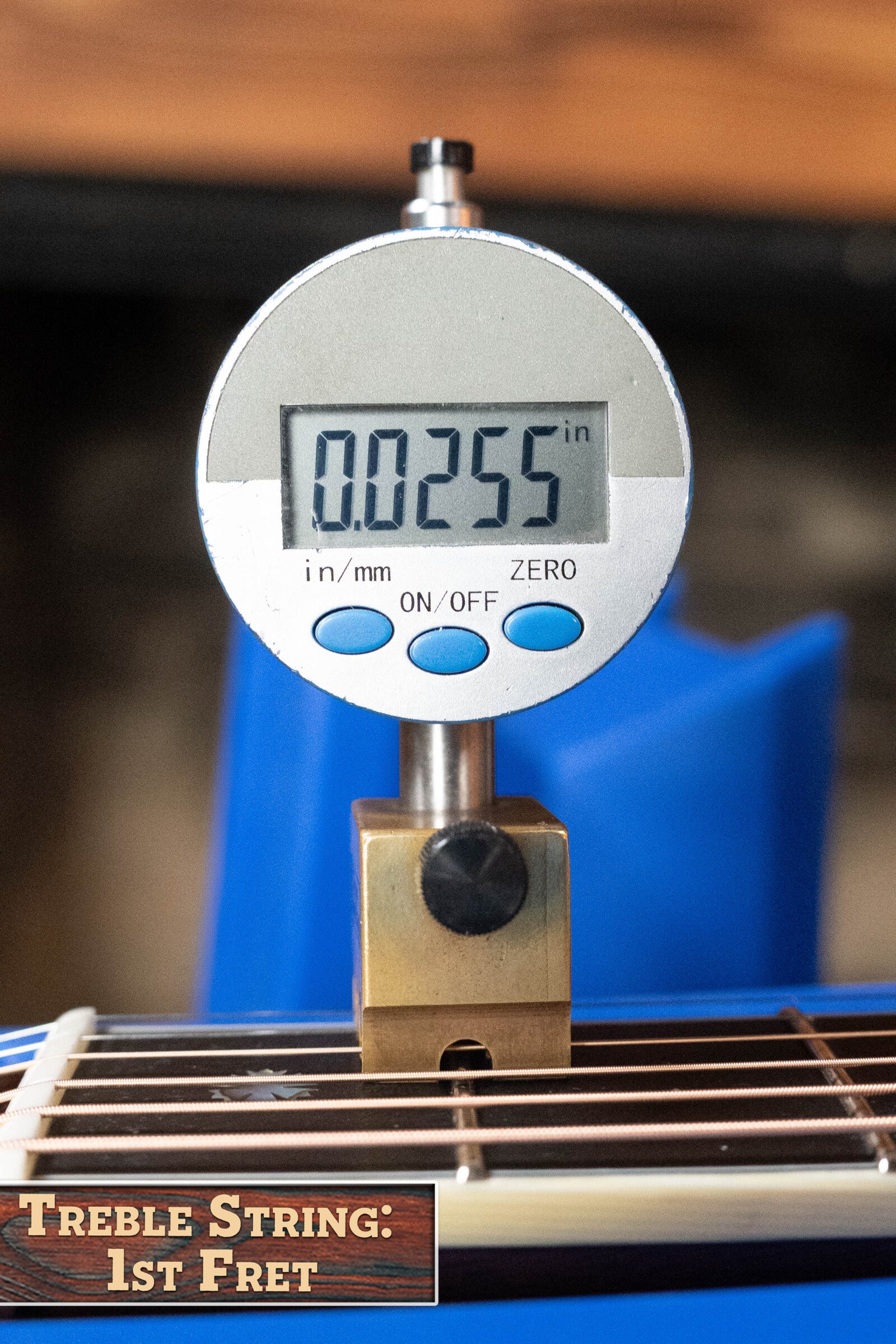 A digital caliper shows 0.0255 inches above the first fret of an Eastman Guitars E40D-TC-SB Thermo-cured Adirondack/Rosewood Sunburst Dreadnought Acoustic Guitar #1113, labeled Treble String: 1st Fret in the lower left corner.
