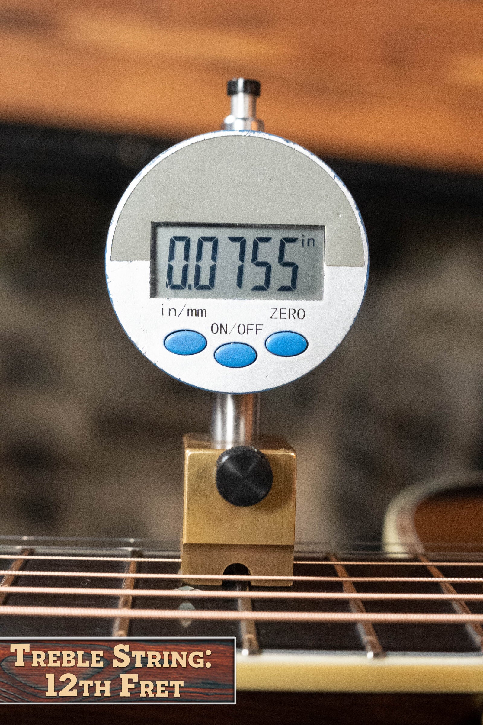 A digital gauge reads 0.0755 inches when measuring the treble string height above the 12th fret on an Eastman Guitars E40D-TC-SB Thermo-cured AAA Adirondack/Rosewood Sunburst Dreadnought Acoustic Guitar #1113.