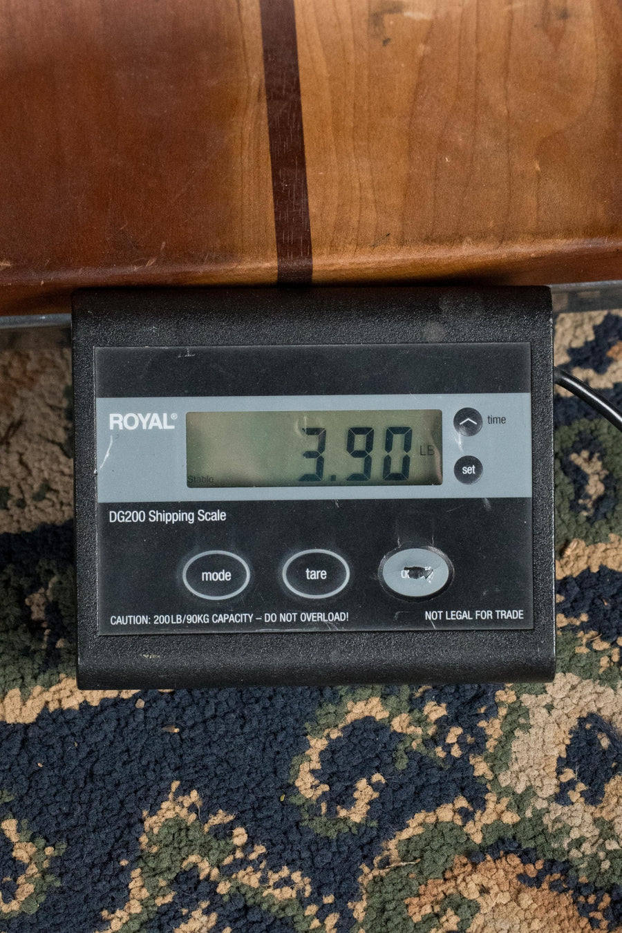 Black digital scale displaying 3.90 pounds with wood guitar neck above on patterned carpet. - Eastman E6-LGSS-TC-SB Thermo-Cured Sitka/Mahogany LG-Style Slope Shoulder Sunburst Acoustic Guitar #9348 - Default Title
