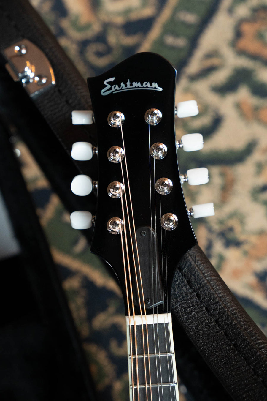 Black Eastman MD404-BK A-style mandolin headstock with white tuning pegs and silver strings. - Eastman MD404-BK Black Top Oval Hole A-Style Mandolin #0083 - Default Title