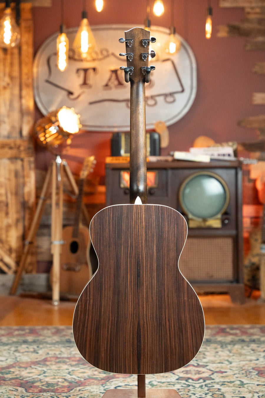 Gloss black top acoustic guitar with Sitka and laminated rosewood back showing natural wood grain and smooth finish. - Eastman PCH2-OM-BK Solid Thermo-Cured Sitka/Laminated Rosewood Orchestra Model Gloss Black Top Acoustic Guitar #1078 - Default Title