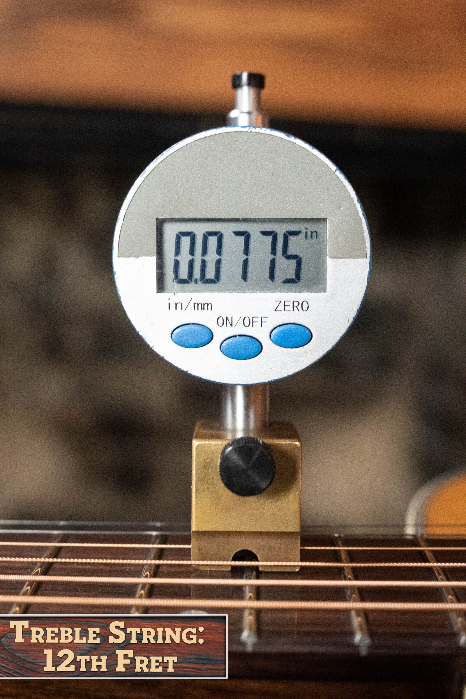 A digital gauge reads 0.0775 at the 12th fret treble string of the Eastman Guitars PCH2-TG Thermo-Cured Solid Sitka/Laminated Rosewood Travel Acoustic Guitar #9714, labeled Treble String: 12th Fret.