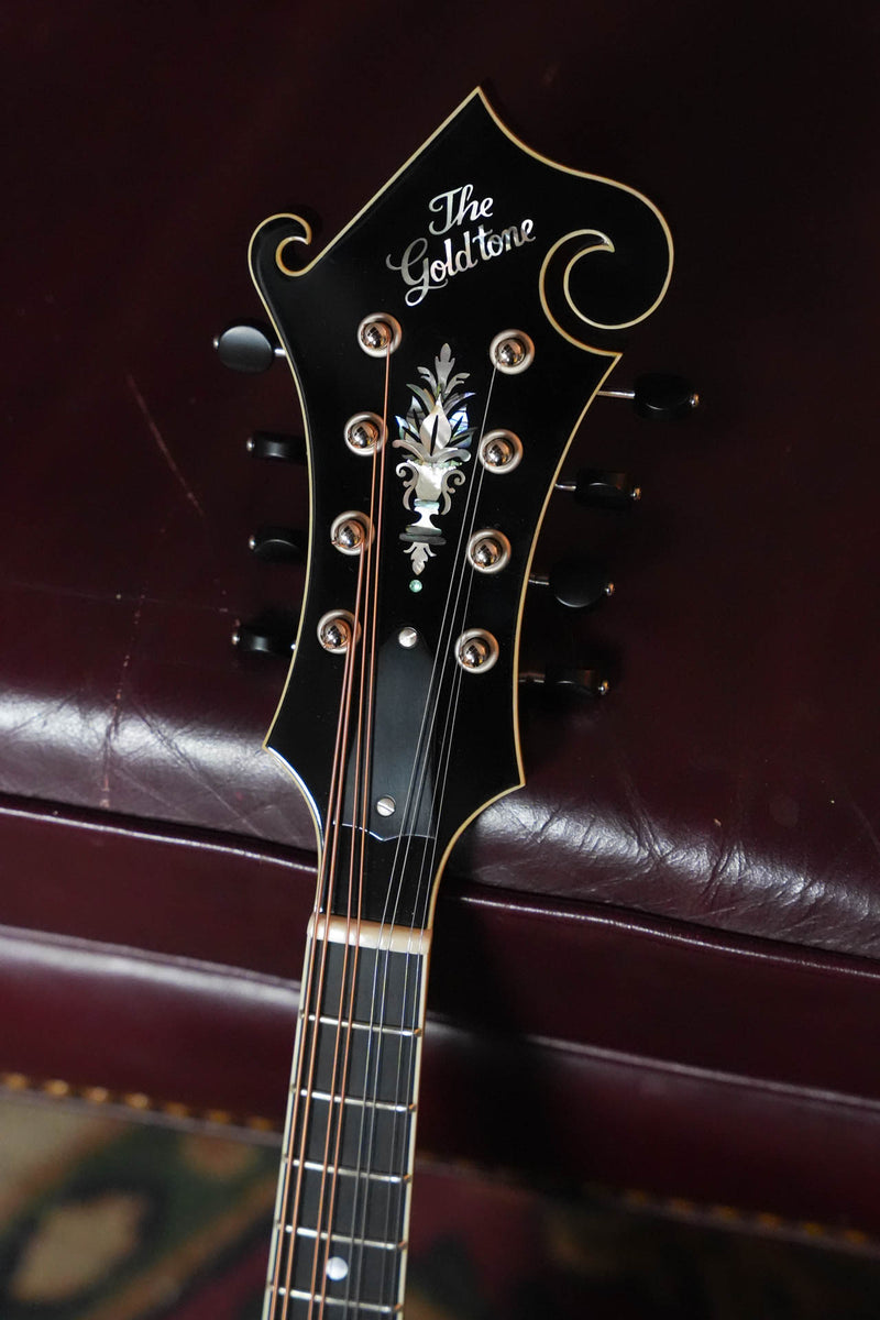 Gold Tone Grandmaster Mandolin Elite headstock, burst finish, ornate inlay and black tuning pegs.