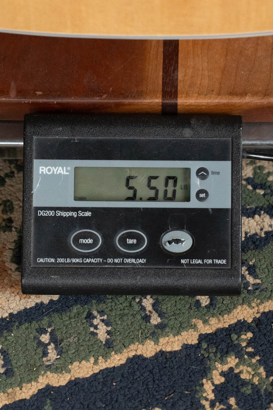 Digital scale displaying 5.50 pounds with a patterned rug underneath. - Guild F-512E Sitka/Flamed Maple 12 String Maple Blonde Jumbo Guitar w/LR Baggs Electronics #0556 - Default Title