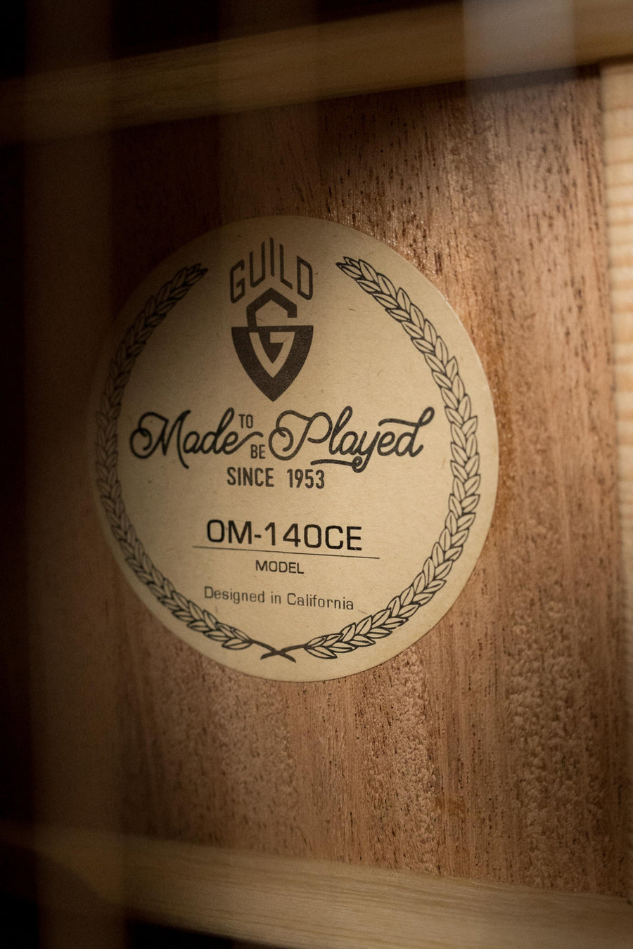 Close-up of Guild OM-140CE guitar label inside natural Sitka spruce and African mahogany body. - Guild OM-140CE Sitka/African Mahogany Natural OM Cutaway Guitar w/Electronics #4964 - Default Title
