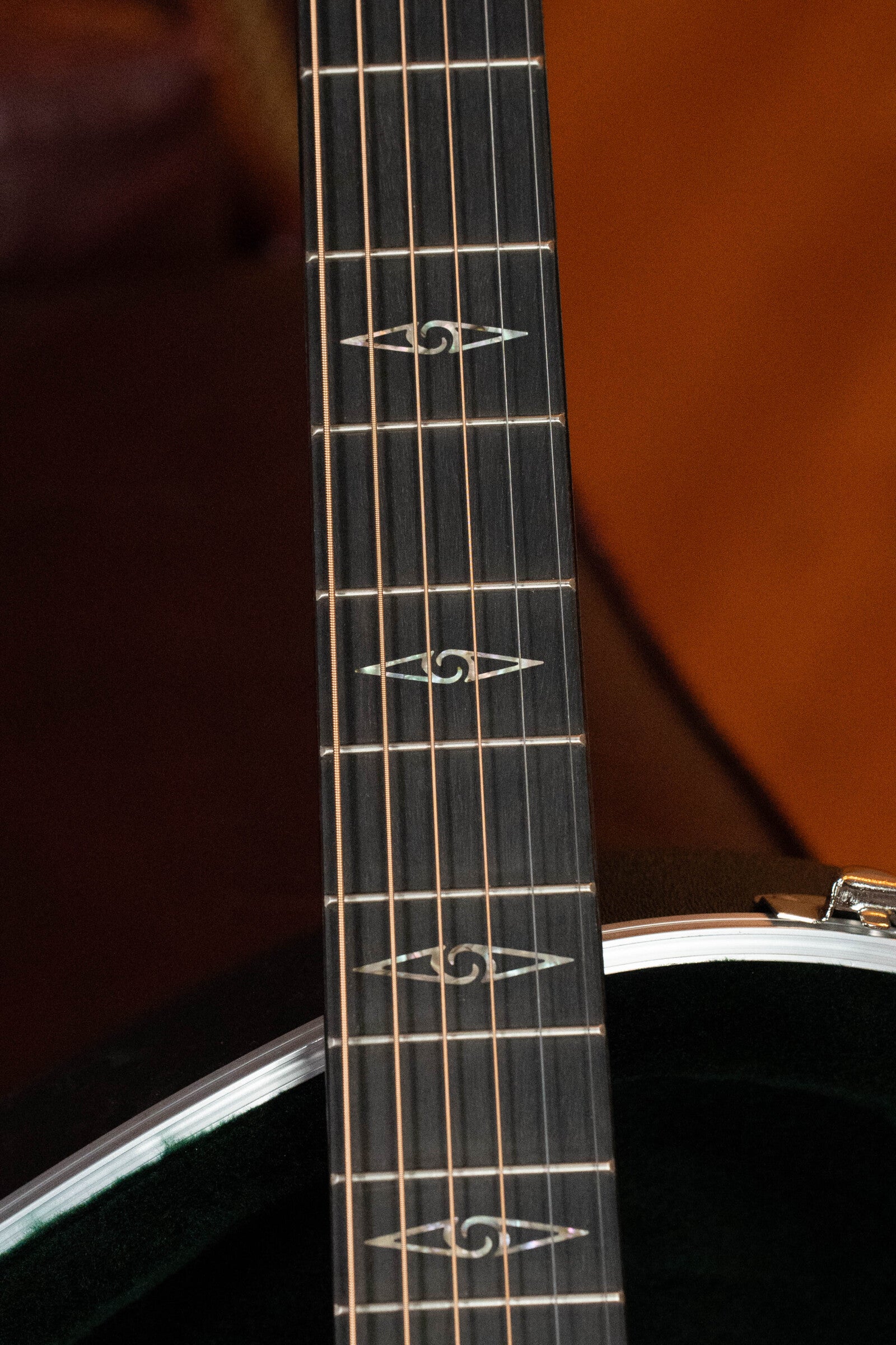 A close-up of the Martin & Co. *Limited Edition* CEO-11 Grand Auditorium Guitar (#1204) in New Horizons Blue Burst, highlighting its neck, fretboard with decorative inlays, and part of its spruce/white oak body against a blurred background.