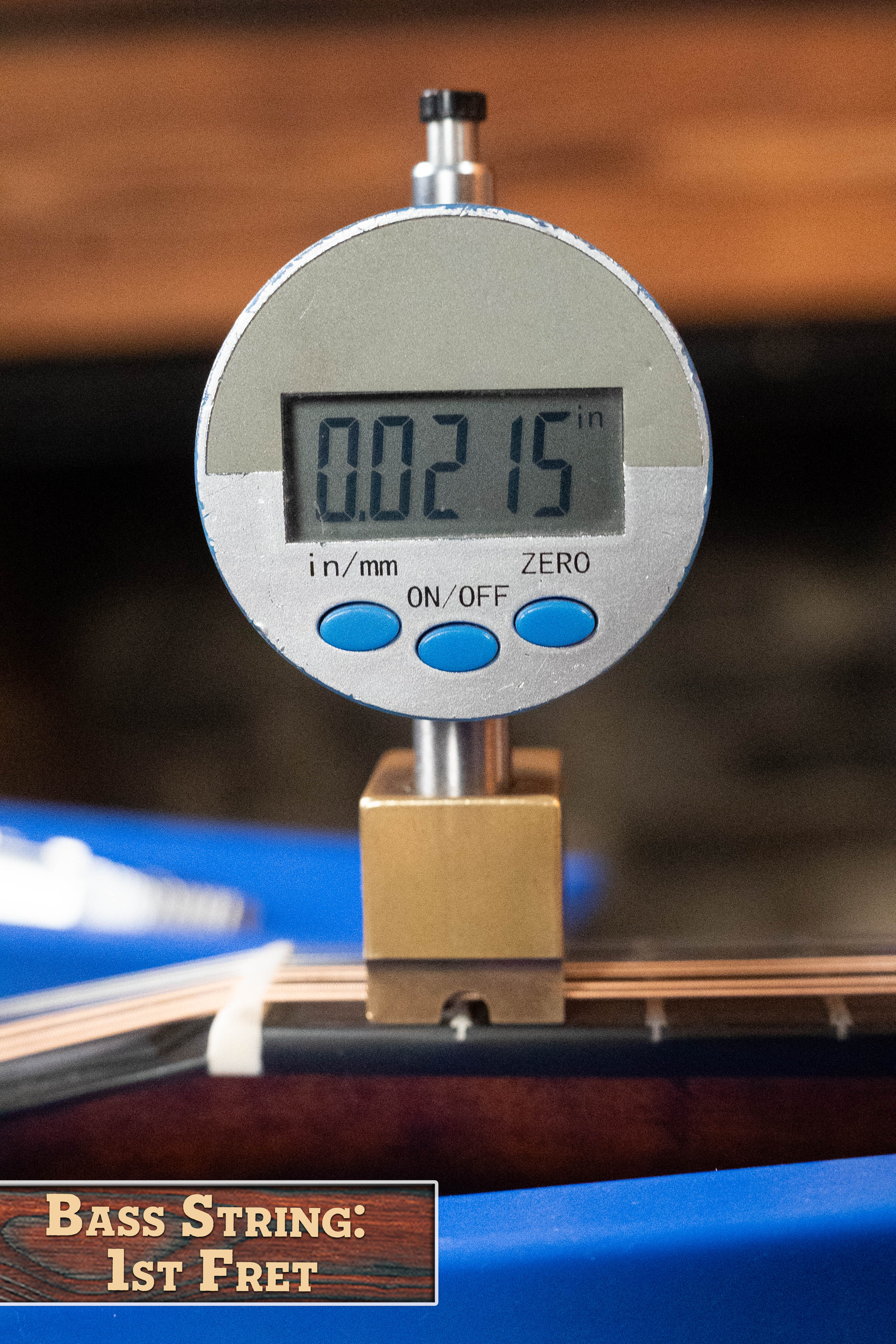 A digital caliper measures the string height at the 1st fret of the Eastman Guitars MD305 Spruce/Maple A-Style Hand-Carved Mandolin #3317, displaying 0.0215 inches, labeled "Mandolin: 1st Fret" for precise setup.