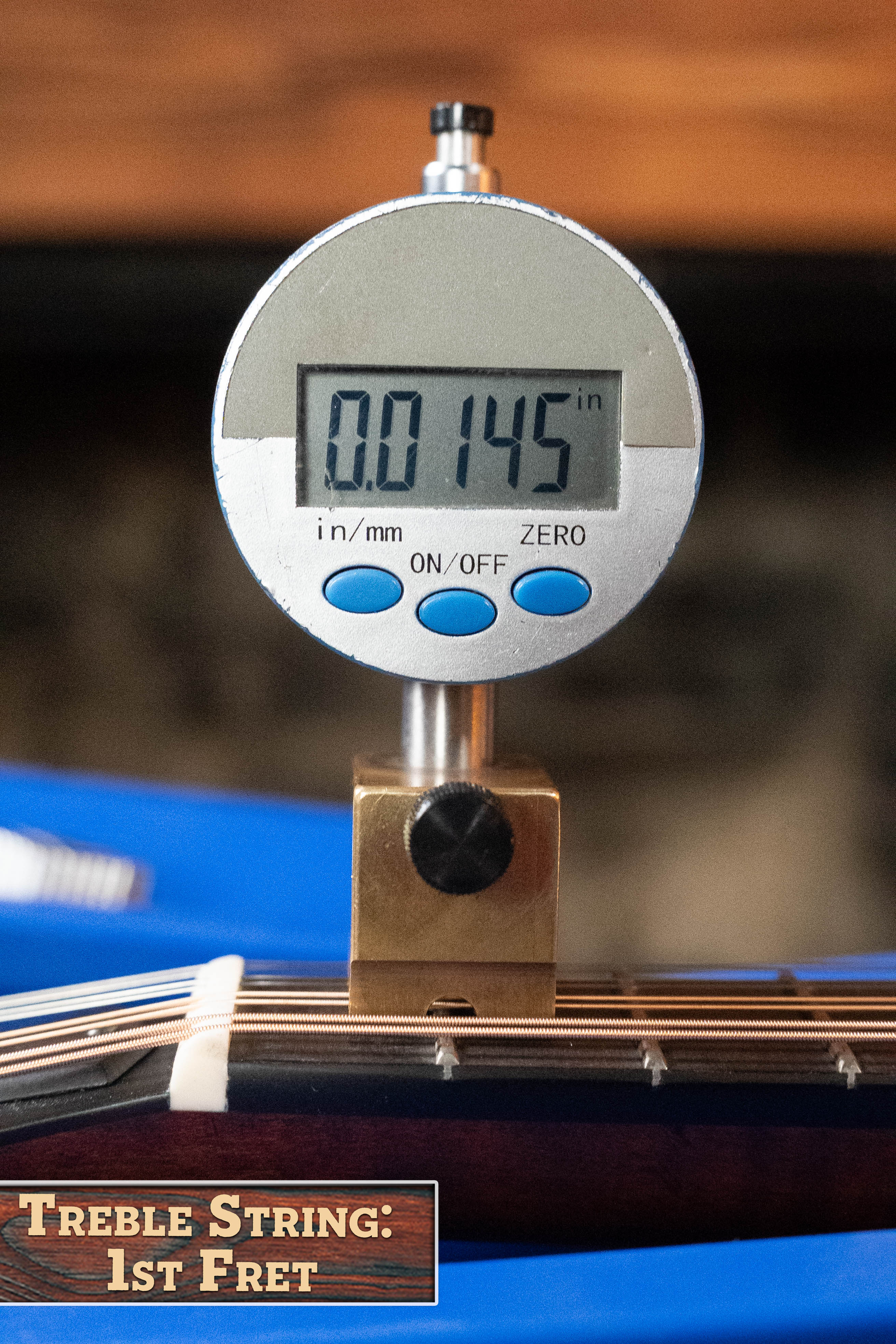 A digital gauge shows 0.0145 inches as the treble string height at the 1st fret on an Eastman Guitars MD305 Spruce/Maple A-Style Hand-Carved Mandolin #3317, labeled "Treble String: 1st Fret.