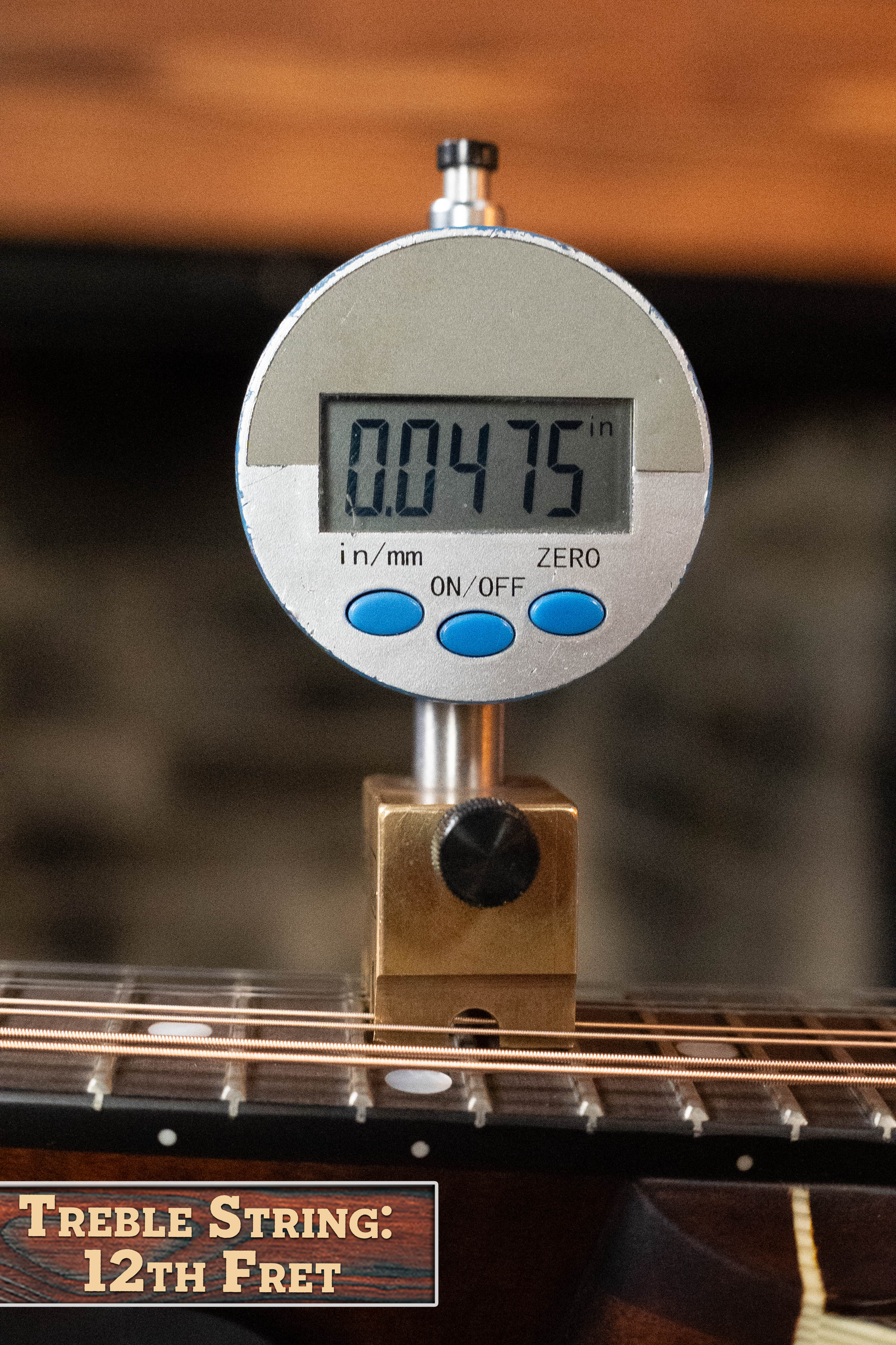 A digital gauge measures 0.0475 in string height at the 12th fret on the Eastman MD305 A-Style Hand-Carved Mandolin by Eastman Guitars—ideal for precise setup of your carved-top mandolin.