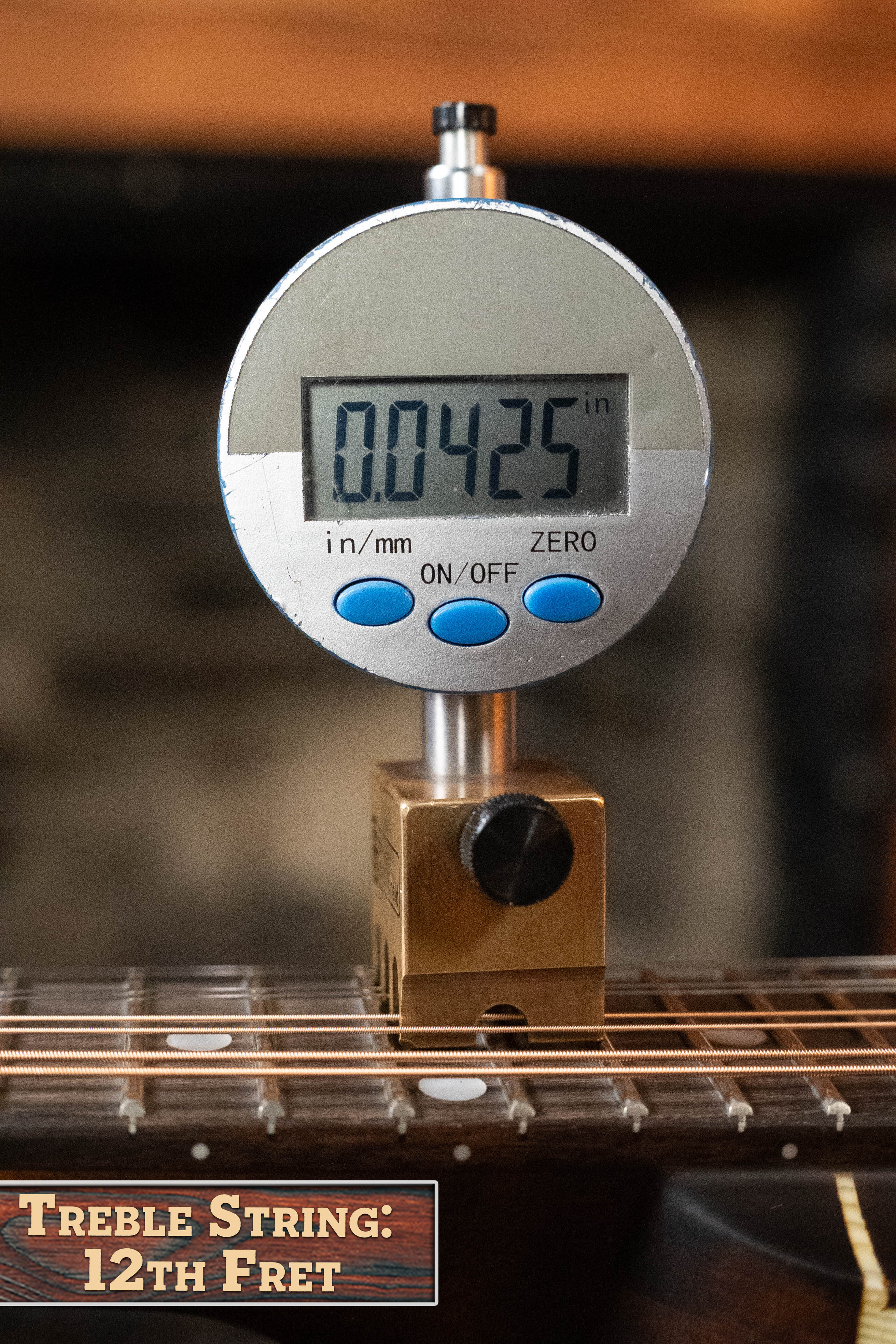 A digital gauge shows 0.0425 inches measuring the treble string’s height above the 12th fret on the Eastman MD305 Spruce/Maple A-Style Hand-Carved Mandolin #3596 by Eastman Guitars, labeled “Treble String: 12th Fret.”.