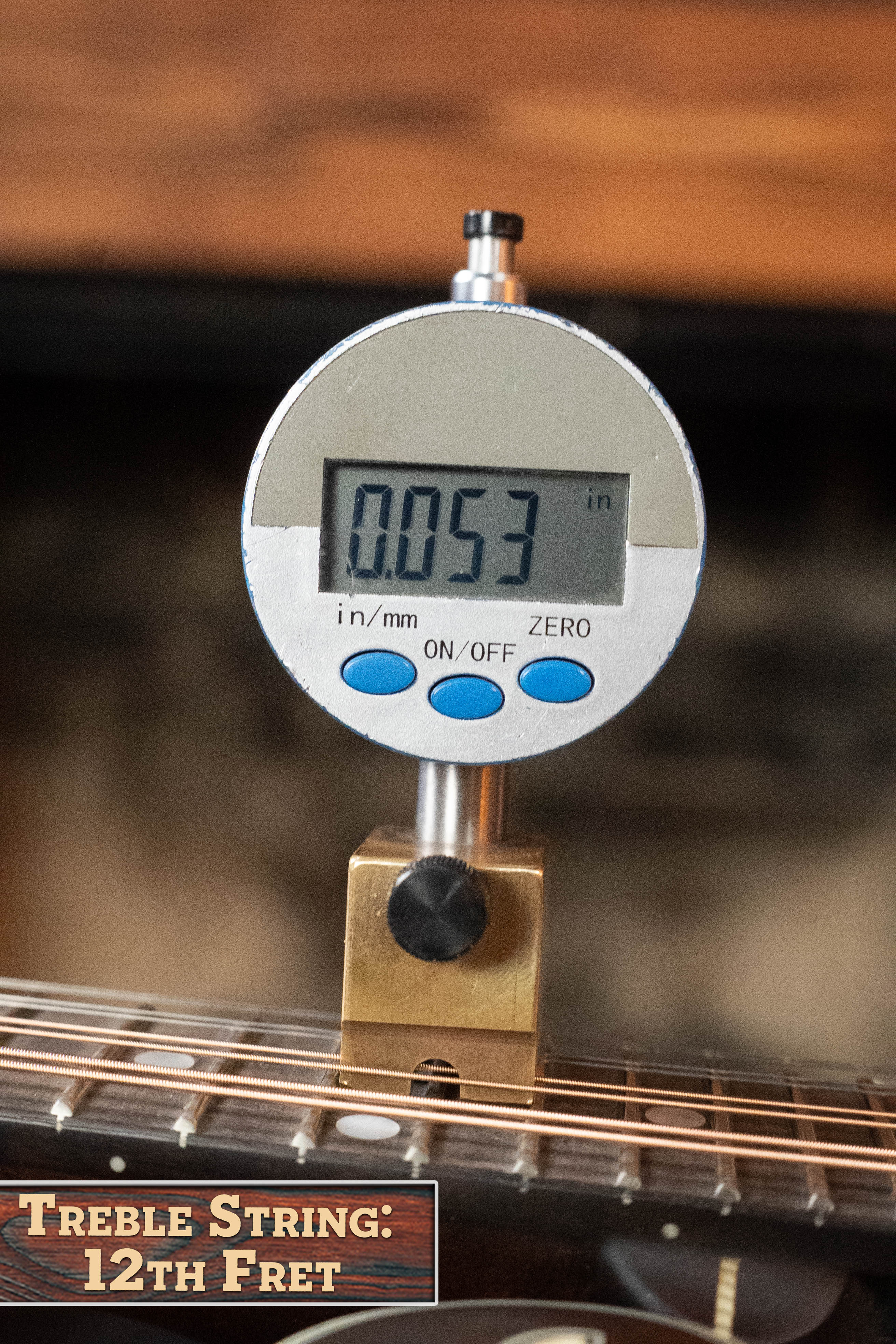 A digital gauge shows 0.053 inches as the string height above the 12th fret on an Eastman MD315 F-Style Hand-Carved Mandolin #0917 by Eastman Guitars. The label reads: Treble String: 12th Fret.