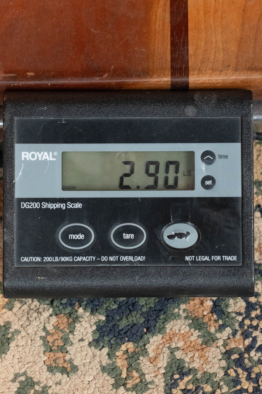 A digital shipping scale reads 2.90 pounds beside a Martin & Co. D-18 Spruce/Mahogany 1935 Gloss Sunburst Finish Dreadnought Acoustic Guitar #8004, both set on a patterned carpet.