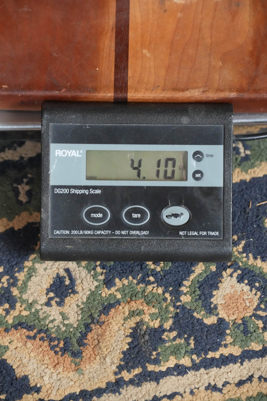 A Martin & Co. D-18 Spruce/Mahogany Acoustic Guitar (#5420) rests on a digital shipping scale on a patterned carpet, displaying a weight of 4.10 pounds.