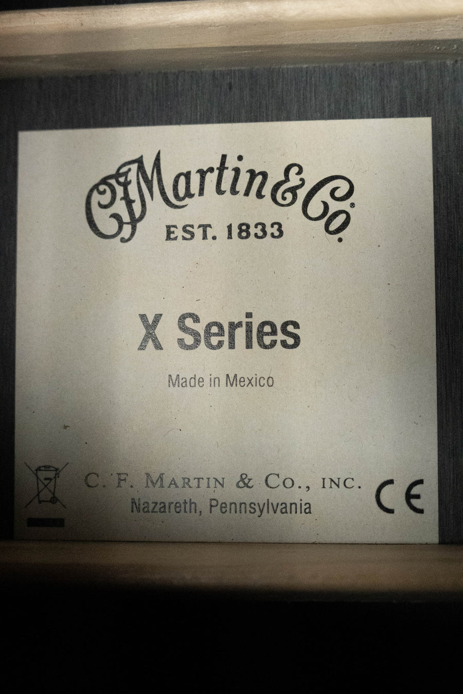 A label inside the Martin & Co. GPC-X1E All Black HPL Grand Performance Cutaway Guitar w/Martin E1 Electronics #1604 reads: Martin & Co. EST. 1833 X Series Made in Mexico, C.F. Martin & Co., Inc., Nazareth, PA, with CE and recycling symbols.