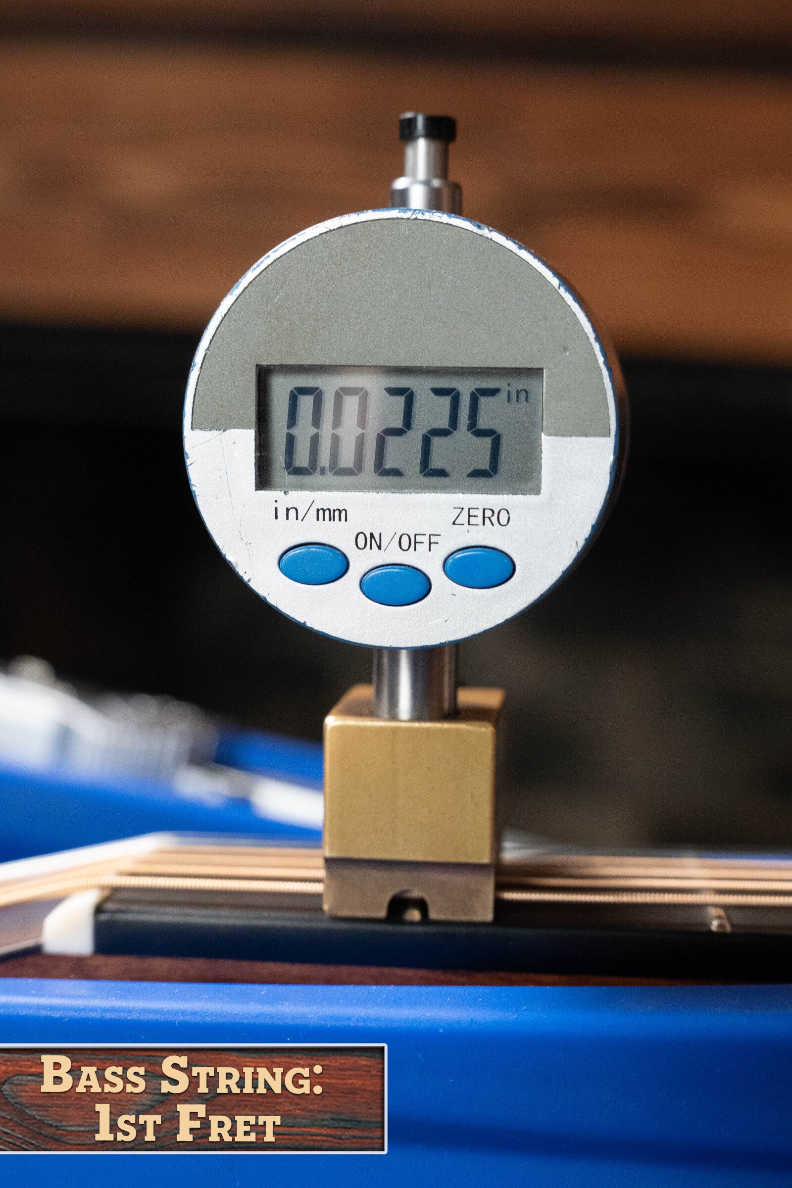 A digital caliper reads 0.0225 inches while measuring the bass string height at the 1st fret of a Martin Custom Shop D-18V Adirondack/Mahogany Dreadnought Acoustic Guitar #6905 by Martin & Co.