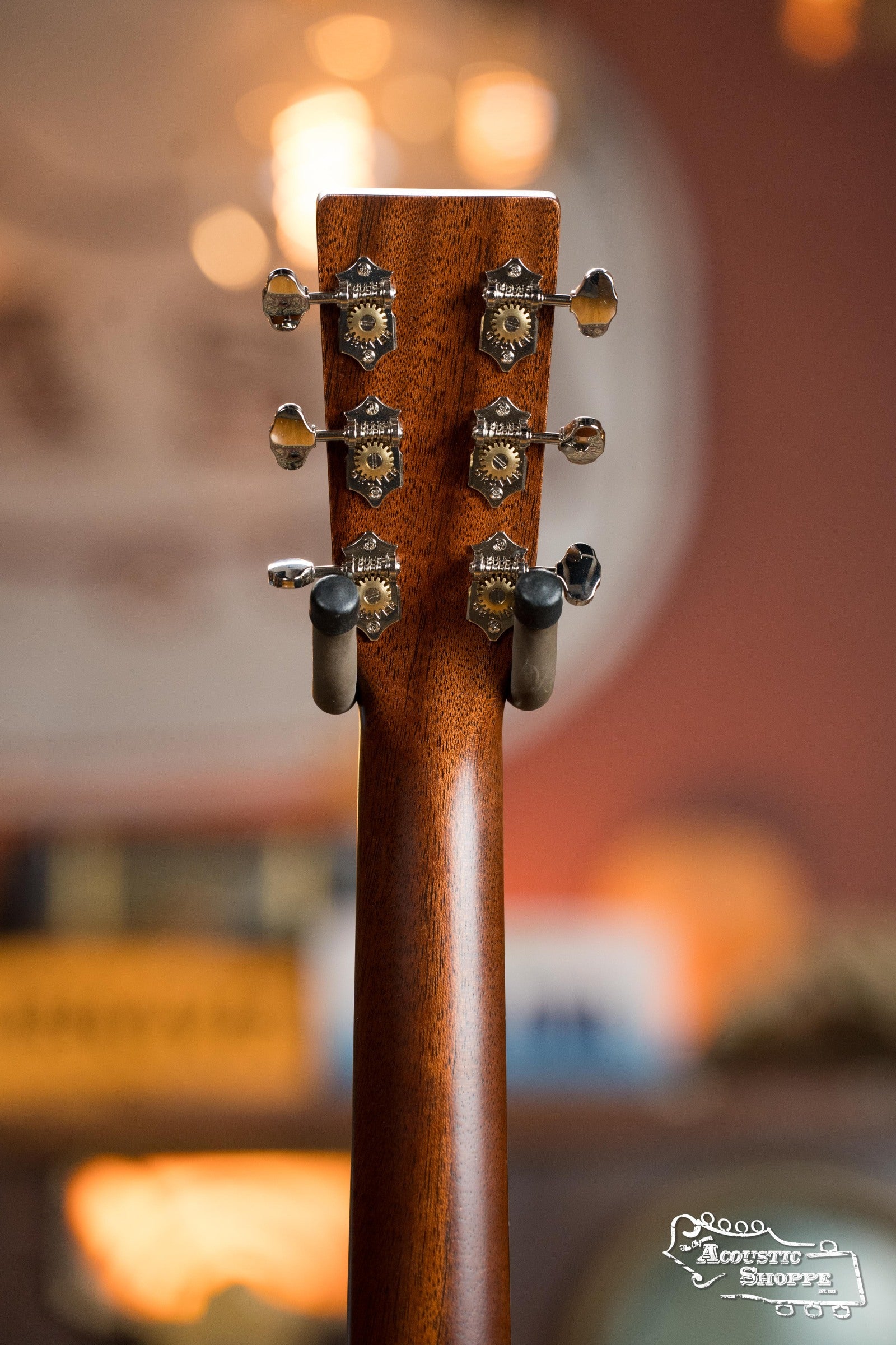 Close-up of the Martin & Co. DE Retro Plus Torrefied Spruce/Mahogany Dreadnought Guitar (#0808) headstock with six tuning pegs, set against a warm blurred background. The Acoustic Shoppe logo appears in the bottom right corner.