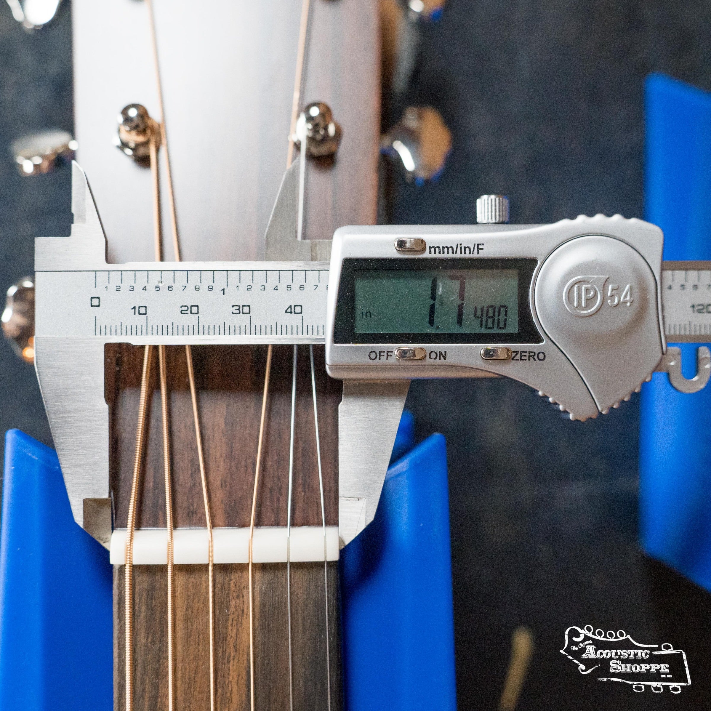 Close-up of a digital caliper measuring the nut width (1.748") on a Martin & Co. DE Retro Plus Torrefied Spruce/Mahogany Dreadnought Guitar w/Martin Electronics #0808, held by blue supports. Acoustic Shoppe logo appears in the bottom right corner.