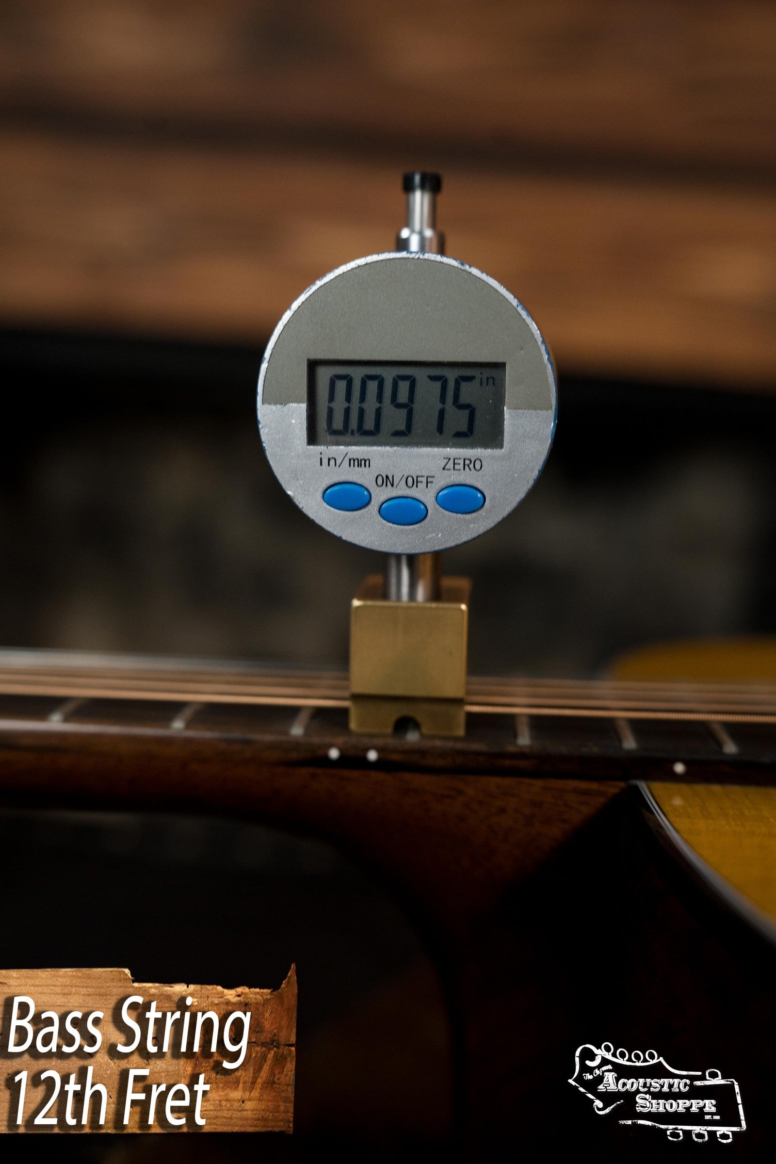 A digital caliper measures 0.0975 inches at the 12th fret of a bass string. Text reads, “Bass String 12th Fret,” with the Acoustic Shoppe logo, known for vintage tone in Martin & Co.’s DE Retro Plus Torrefied Spruce/Mahogany Dreadnought #0808.