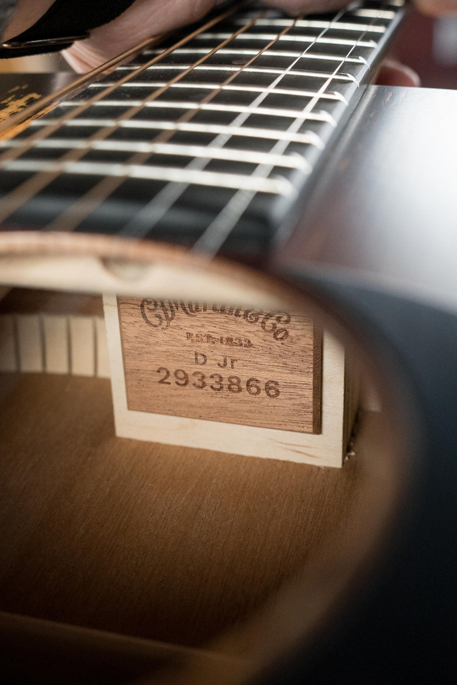A close-up through the sound hole of a *New 2025 Model* Martin & Co. D Jr E Streetlegend Burst shows label #3866 on this aged-look spruce/sapele dreadnought guitar with built-in Martin electronics.