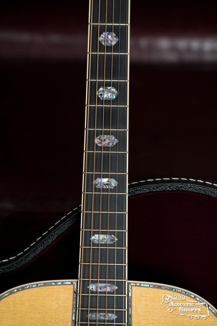Close-up of a Martin & Co. *NEW 2025* OM-45 Spruce/Rosewood Acoustic Guitar (#5120) neck and body, against a dark background, highlighting decorative fretboard inlays and the “Acoustic Shoppe” logo on the lower bout.